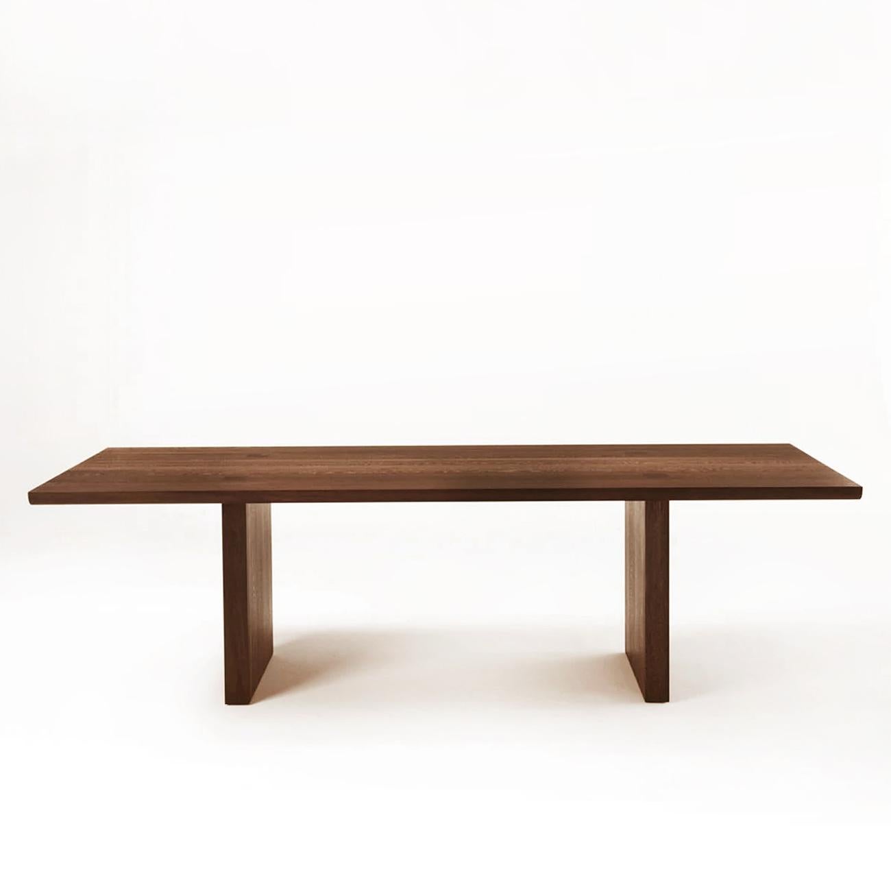 Dining table Theos in solid walnut wood, with a gap in the
middle of the top, with visible squares feet's fixations
on the top. With rounded edges.
Also available in solid oak, on request.
Available in:
L180xD100xH75cm, price: