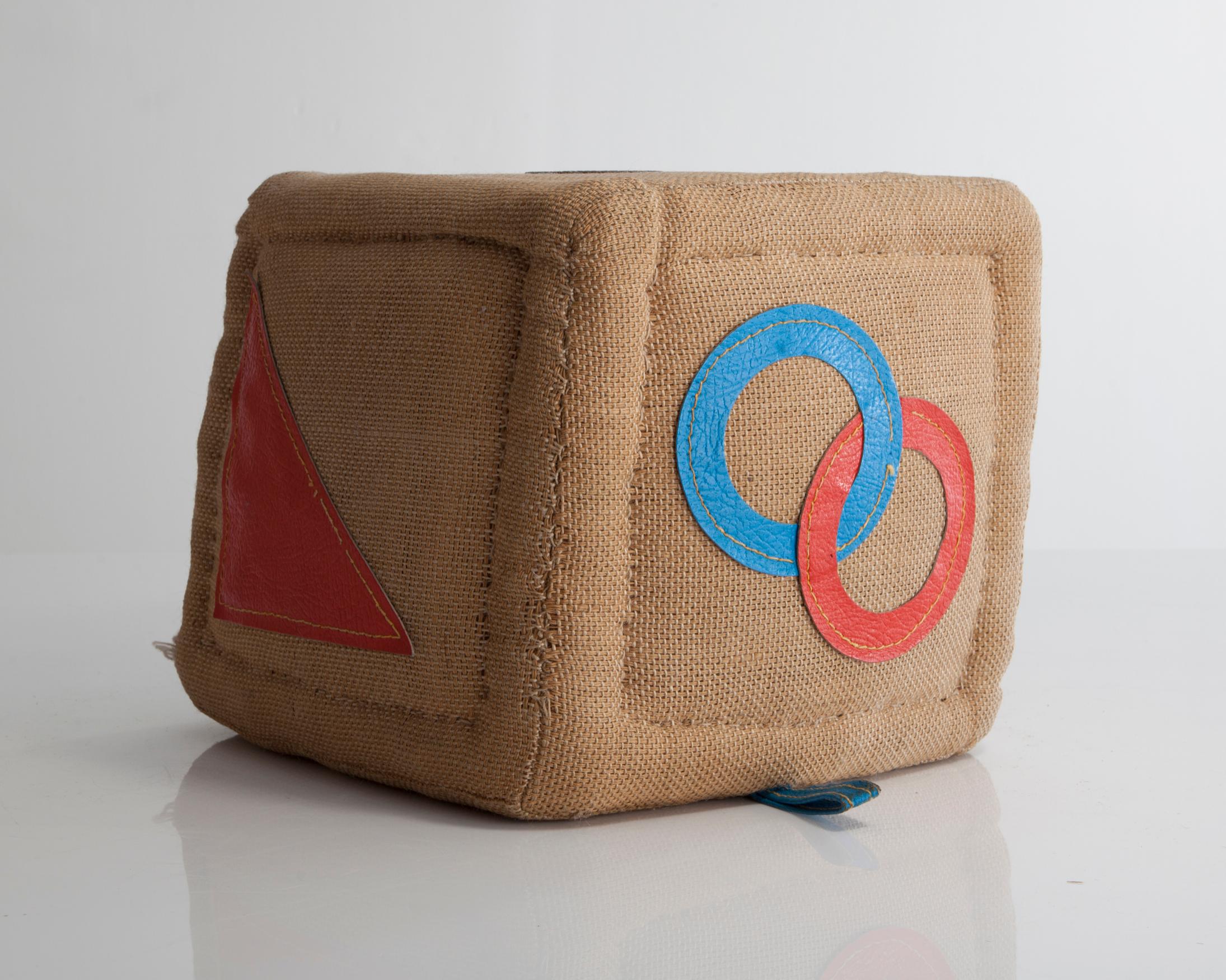 Therapeutic Toy cube in jute with leather detailing. Designed and made by Renate Müller for H. Josef Leven, Sonneberg, Germany, produced between 1968 and 1974.
 