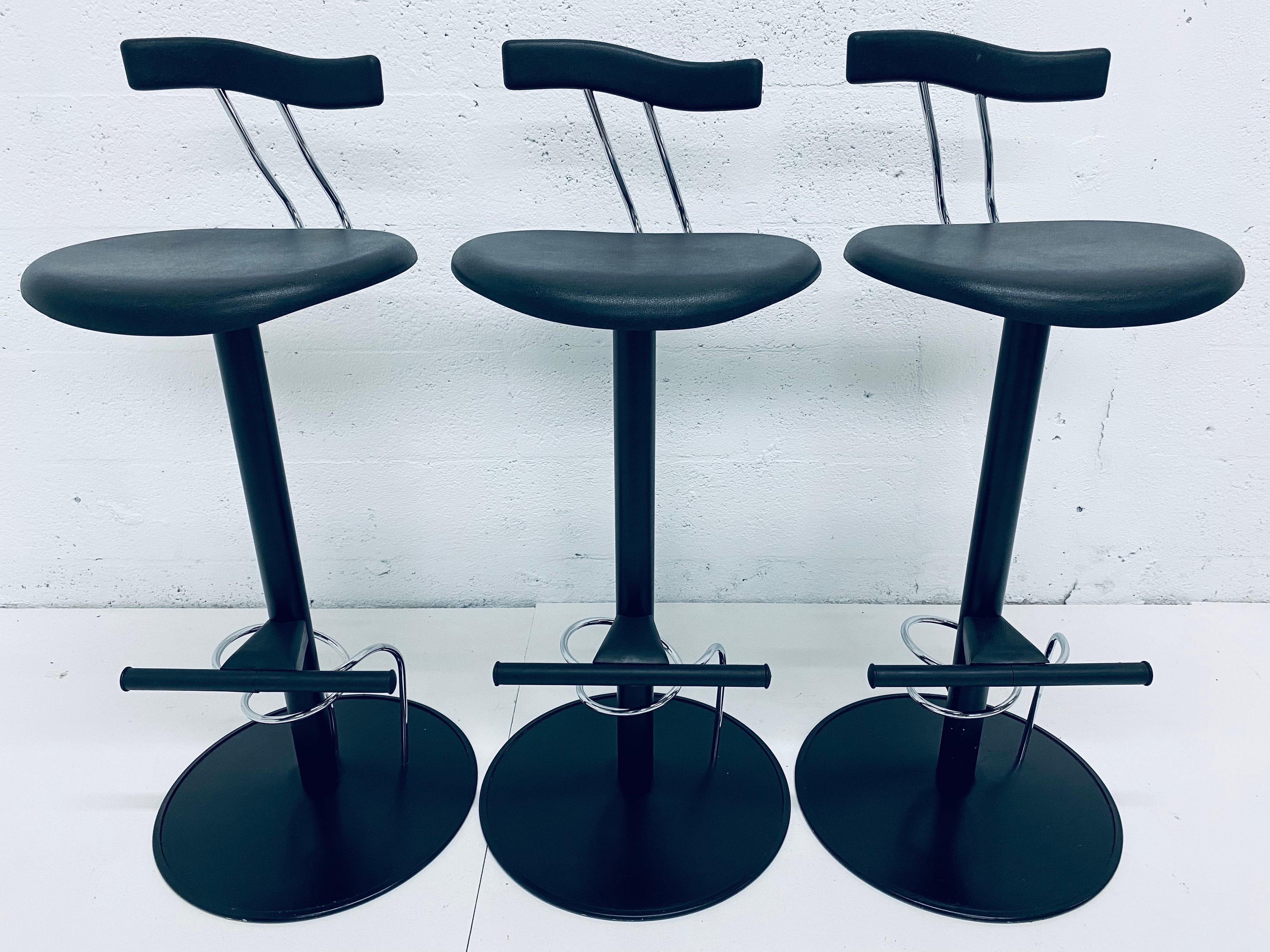 Three bar height Italian Postmodern bar chairs inspired by Memphis Milano. Made of black lacquered steel with black moulded rubber seats and backs.