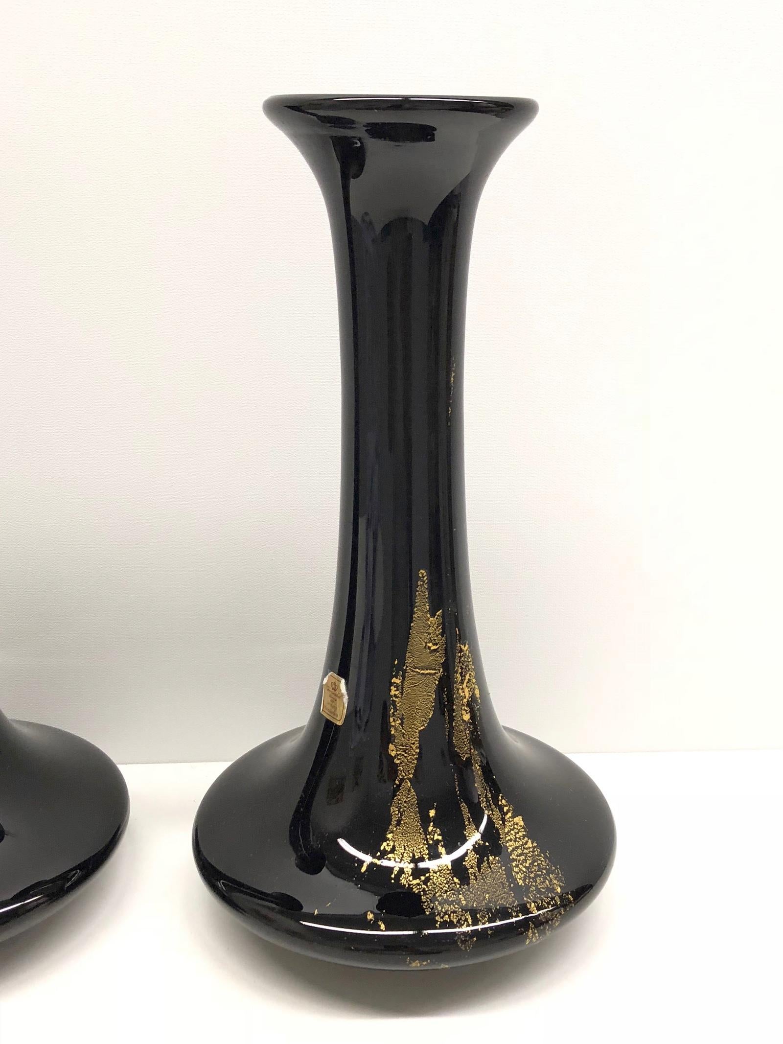 A pair of stylish well shaped black glass vase with two random pattern gold sheet on-lays, under-base with acid etched crown mark and one with the original paper label. Vase are in very good condition with no chips, cracks, or flea bites.