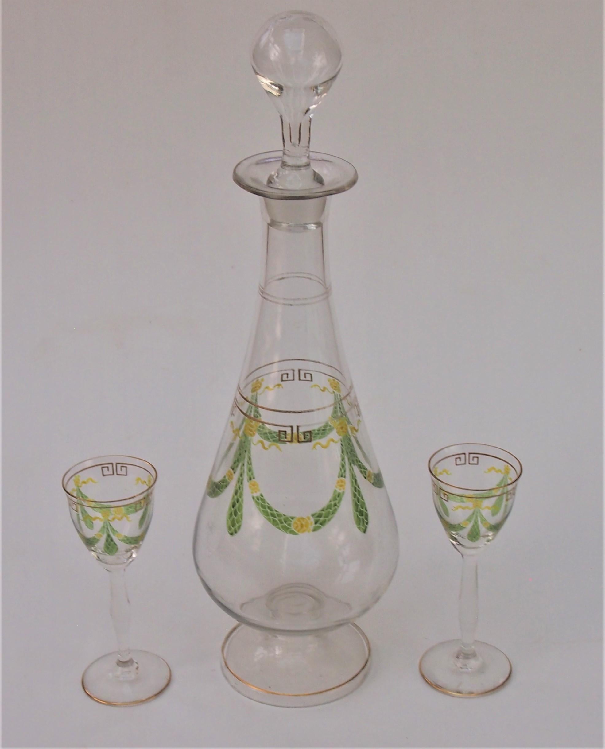 Super Theresienthal set -a large clear and enamel decanter and two small liqueur glasses, decorated in green and yellow translucent enamel swags and garlands in a classic Aesthetic Movement design. The glasses are 12 cms tall - the decanter is 33.5