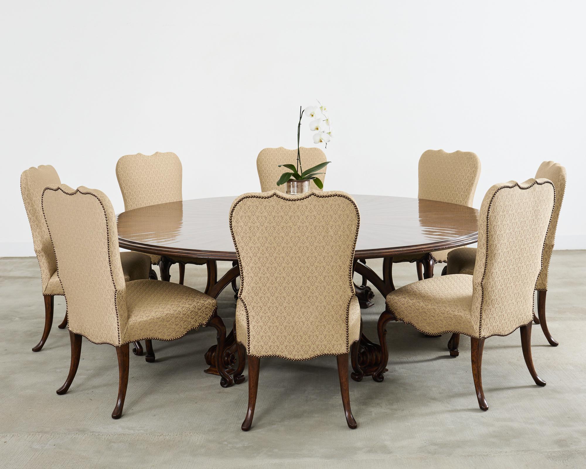 Monumental round walnut dining table crafted in the baroque taste. Designed by Therien Studio workshop for Dessin Fournir, Hollywood, CA. The rare volute dining table crafted from solid walnut features a 2 inch thick round top measuring 8 feet in
