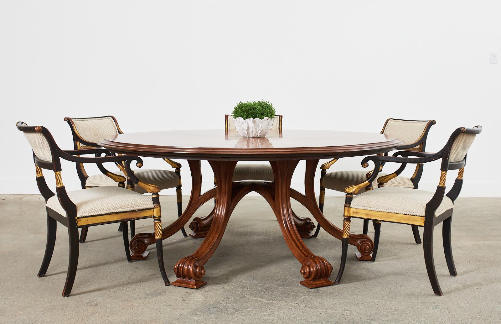 Monumental round walnut dining table with extending leaves from a Craig Wright Installation in Beverly Hills, CA. Bespoke table custom made by Therien Studio Workshop. The Volute dining table crafted from solid walnut with six perimeter leaves