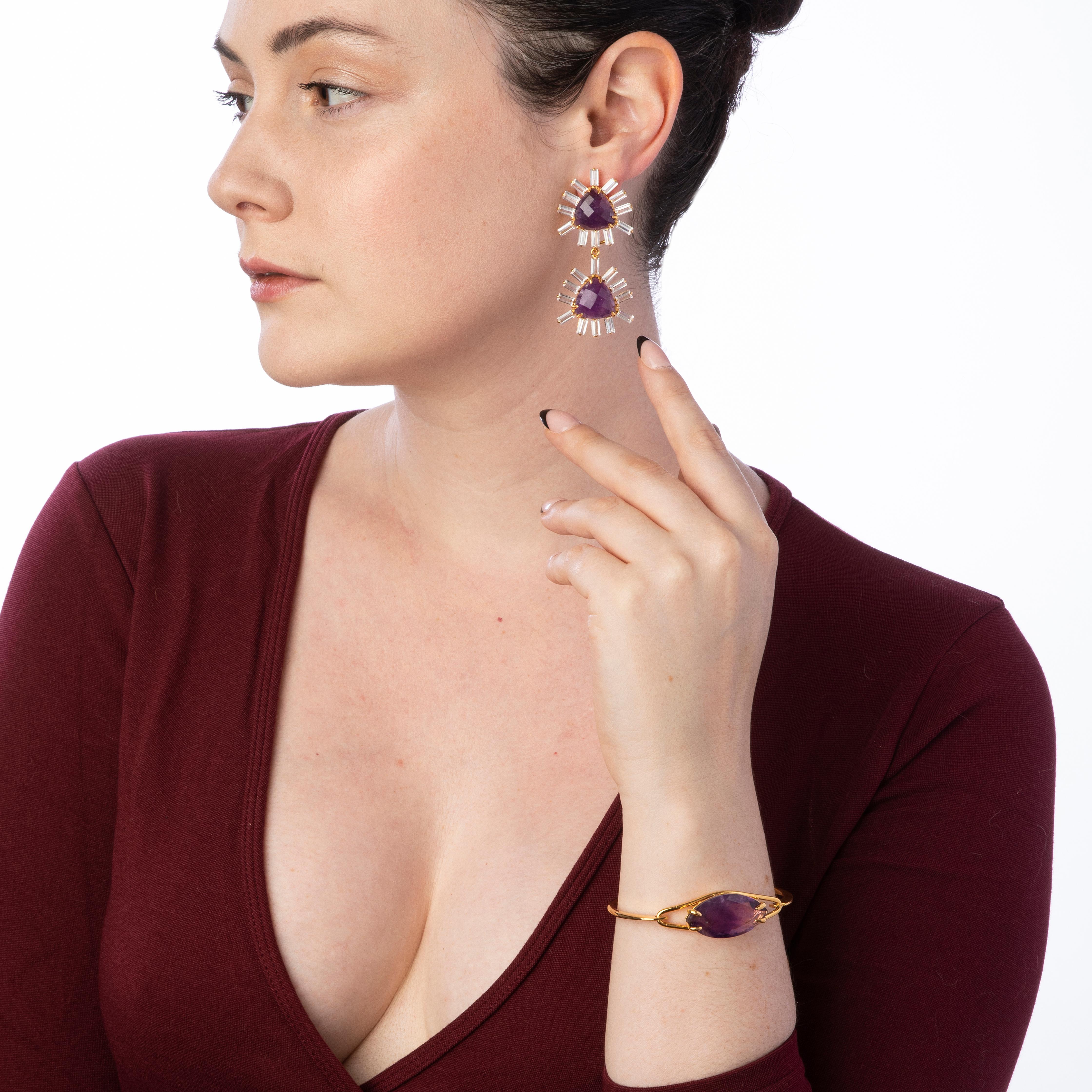 These statement earrings feature faceted triangle-shaped semi-precious stones and clear quartz baguettes, meticulously handcrafted in 14K gold-plated settings. These exquisite dangle earrings offer a burst of vibrant colors, and their detachable