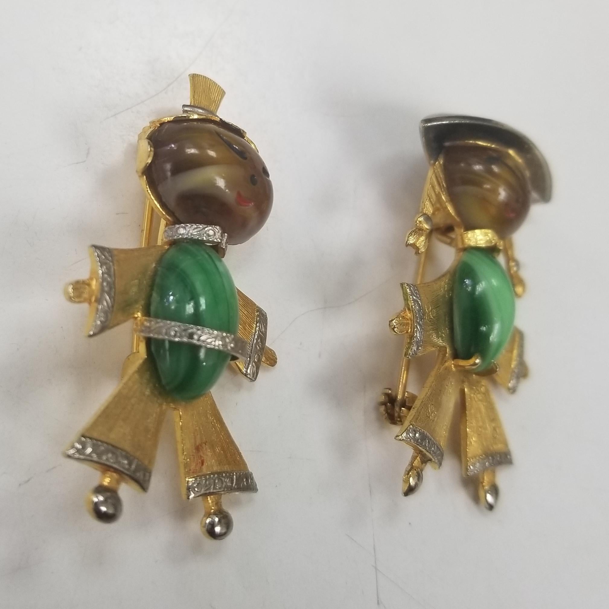 These wonderful vintage pins,  feature the design of an Asian lady and man in a gold tone finish with inset malichite.