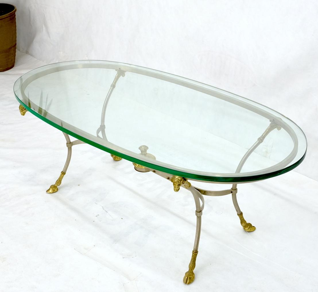 Mid-Century Modern chrome brass and glass top hoof feet motive coffee table. Measure: Thick 3/4