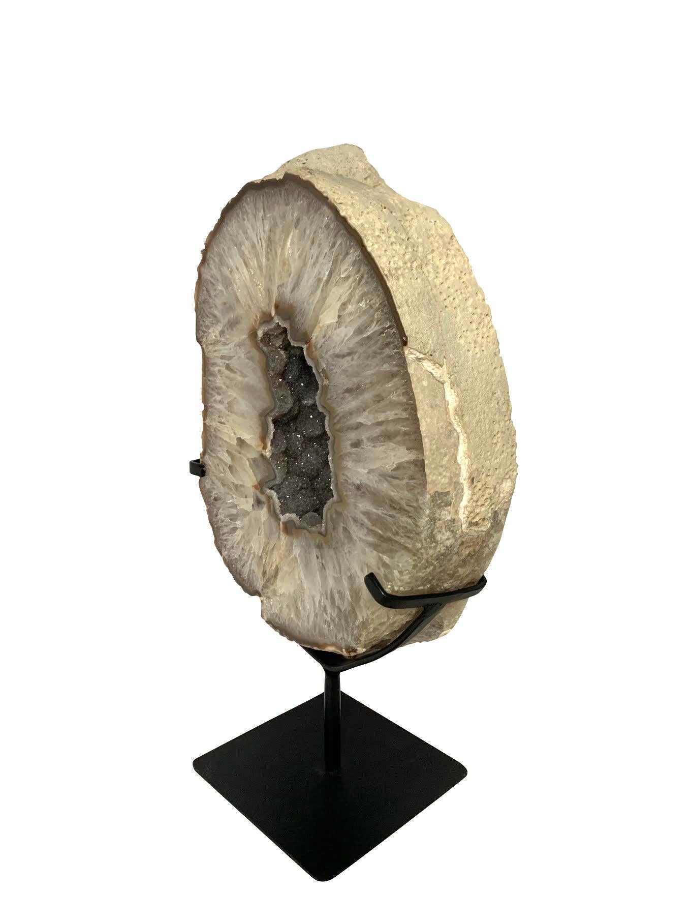 Prehistoric Brazilian thick agate geode on stand.
Center hole reveals beautiful natural silver crystals.
Stand measures 6