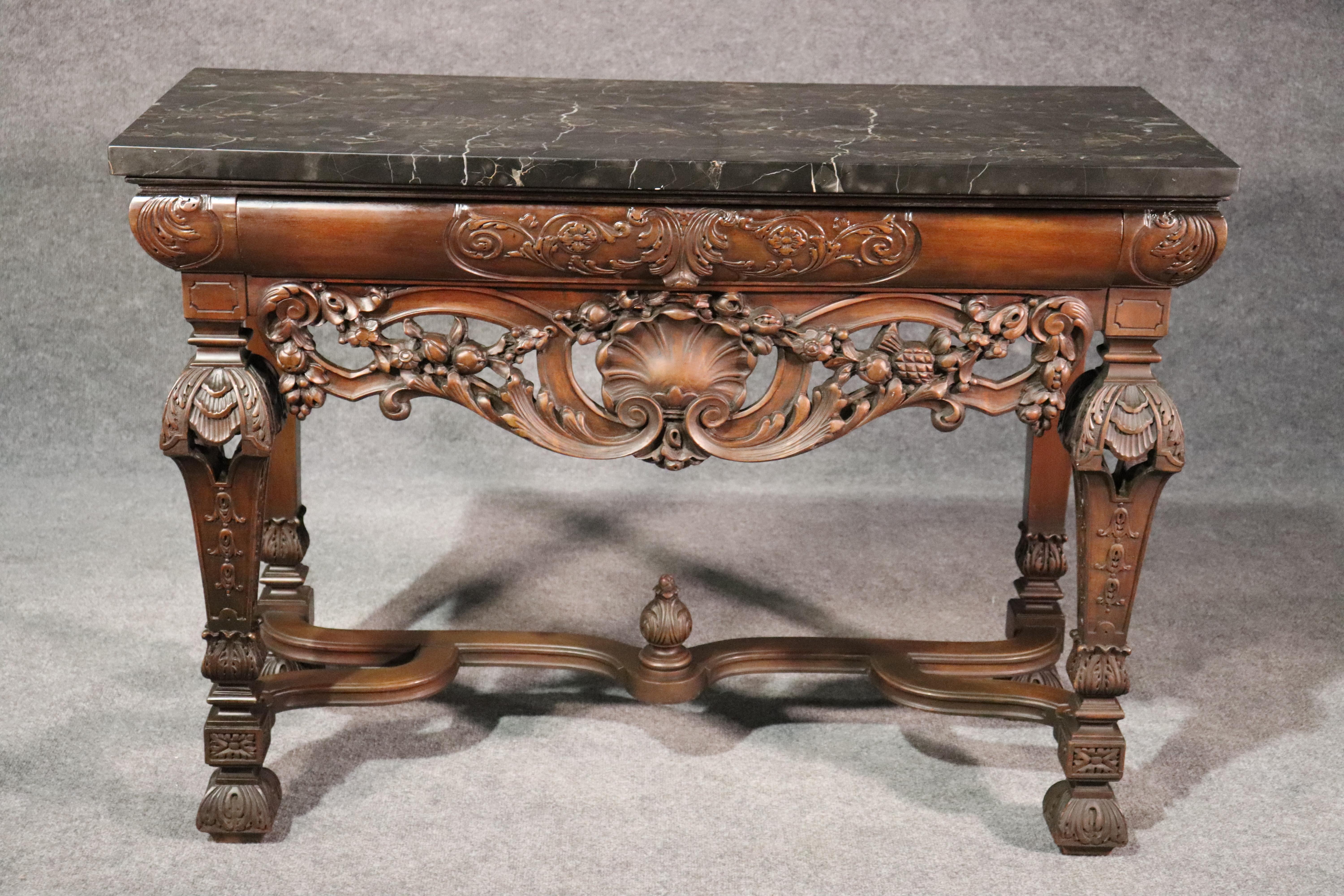 This is a great size console table or server, circa 1920. The table features a double-thick slab of heavy portoro marble with veins of creams, white and on a black field. The frame is solid walnut with oak secondaries for strength. The table is in