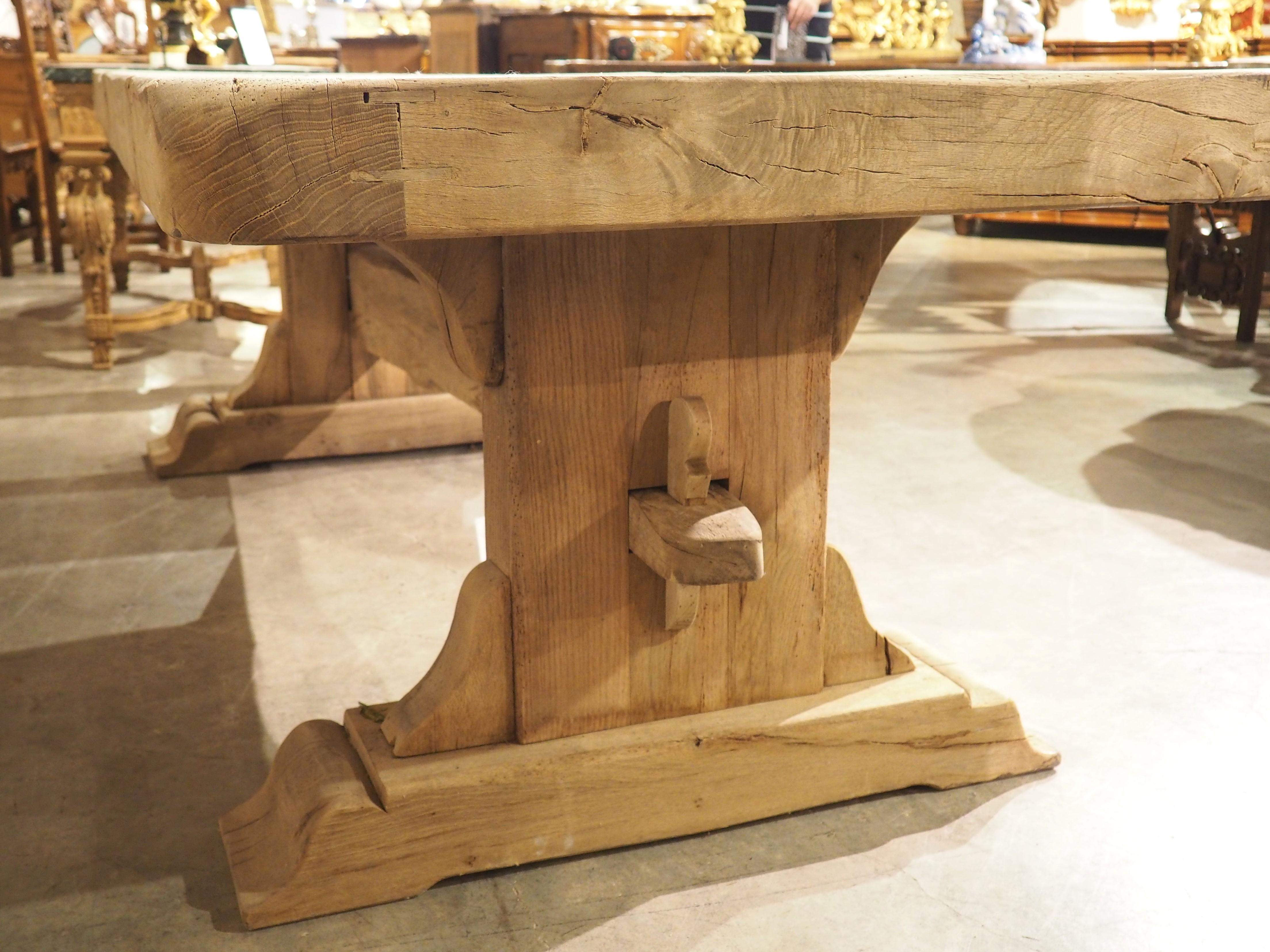 Reminiscent of the robust dining tables used by monks during the Middle Ages, this oak monastery table was hand-carved from oak in France, circa 1950s. Our magnificent table exudes character, boasting a substantial four-inch thick top, with