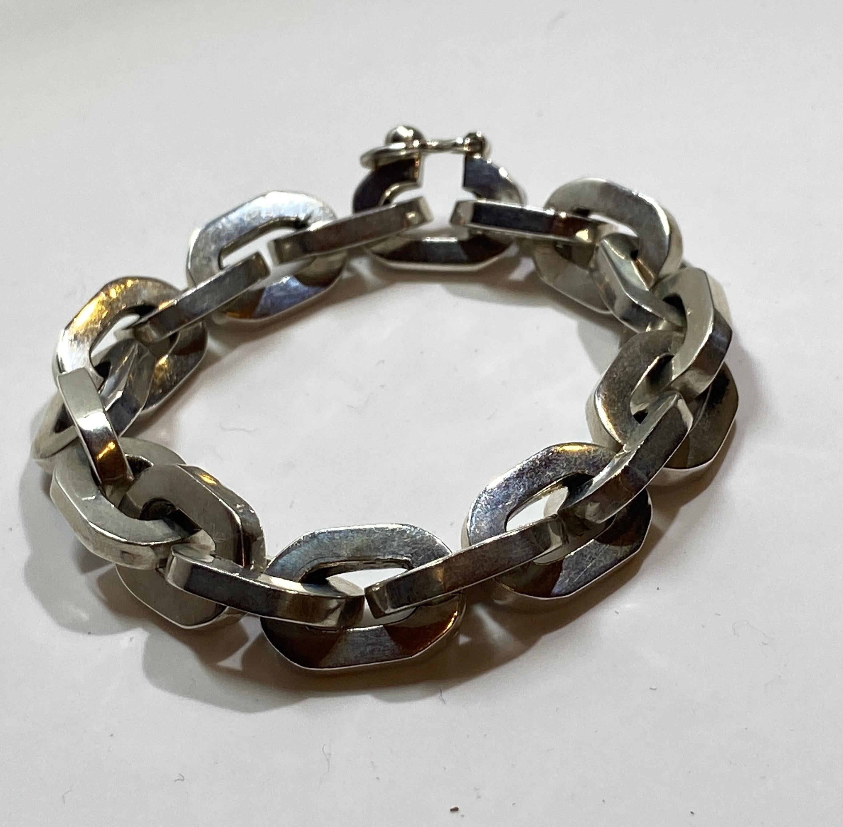 This thick heavy sterling silver chain-link bracelet measures 8 inches in length and 1/2 inch in width. Marked 925 and Made in Mexico.