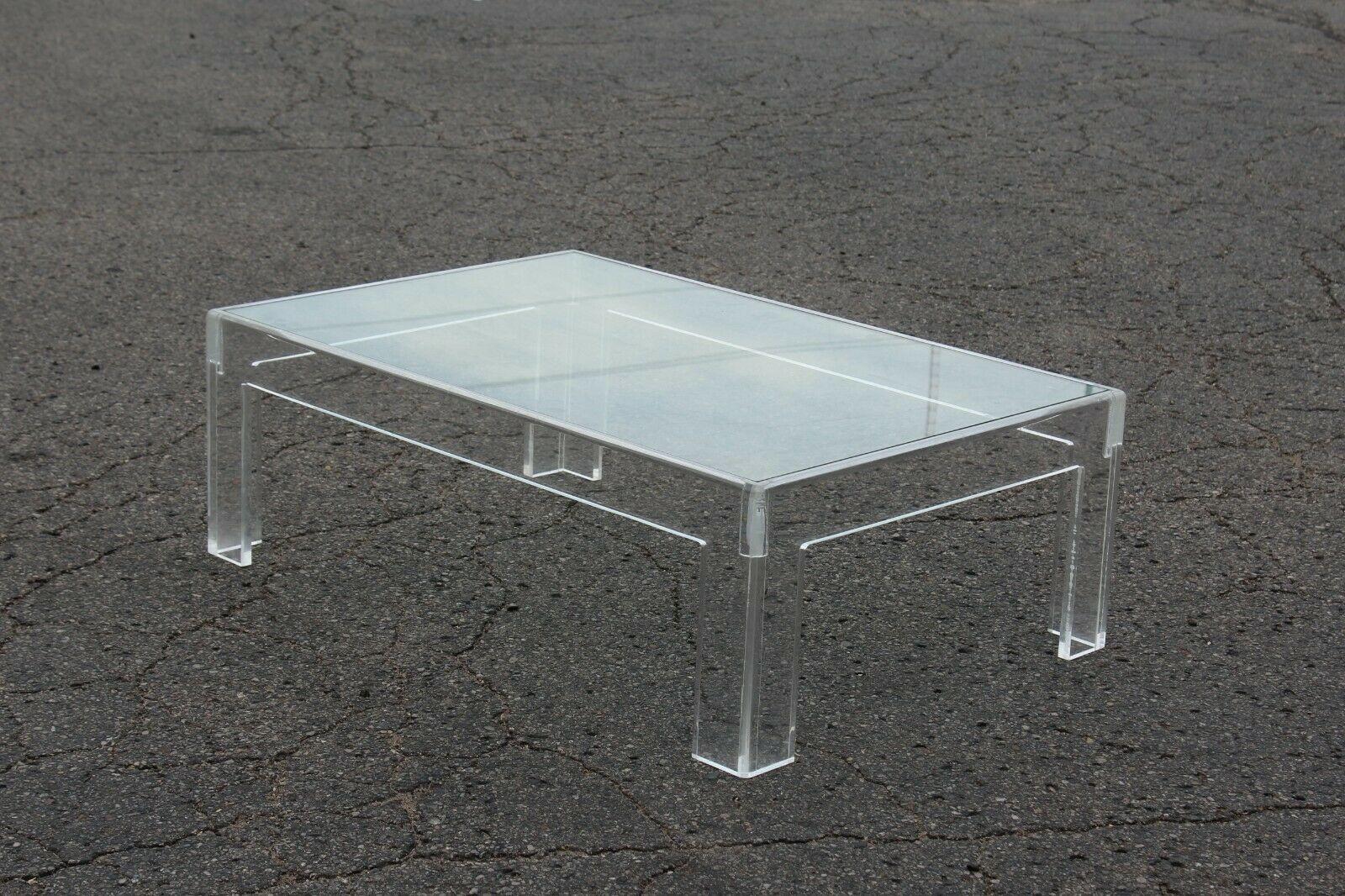 USA, 1970s
 
Thick lucite coffee table in a classic rectangular form. Glass inset top. Very nice in person. The clean lines, classic shape, and transparent qualities mean this can mix with any period of furniture. Lucite measures 3/4