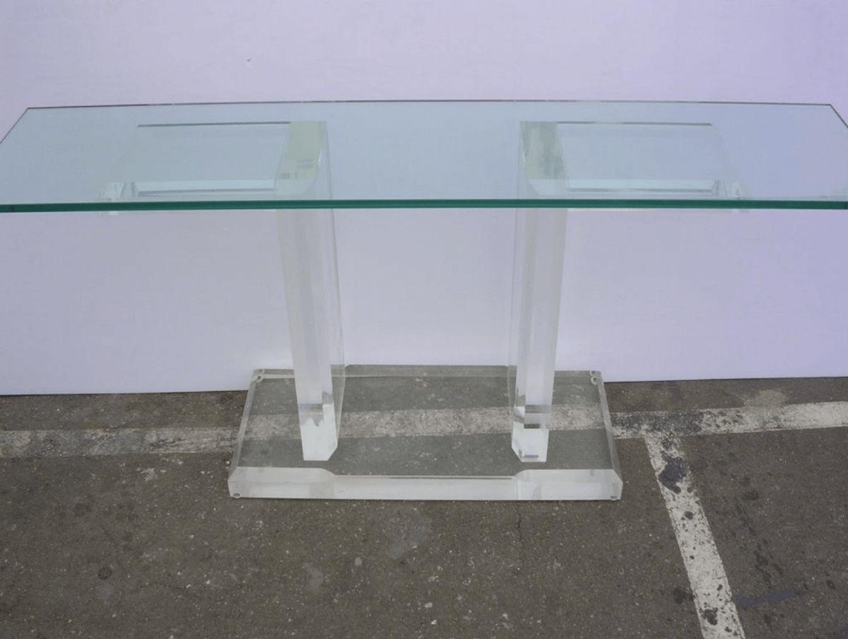 An impressively thick Lucite console in the manner of Karl Springer with glass top. Base is 