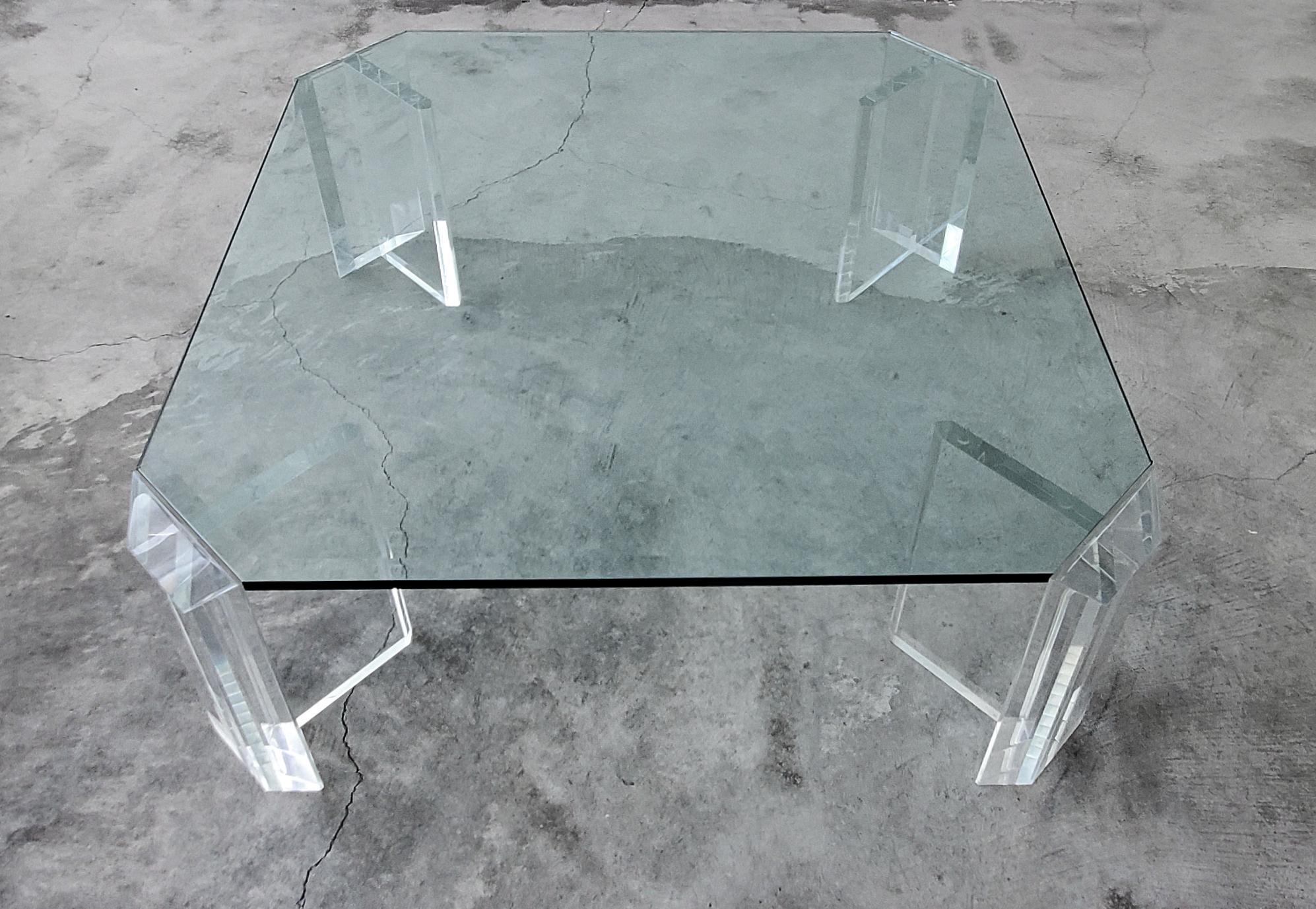 A stunning example of vintage Lucite, by the Master of Lucite himself, Charles Hollis Jones. This thick Lucite midcentury coffee table is large but the combination of glass and lucite takes up little visual space. The thick diagonal cut sections of