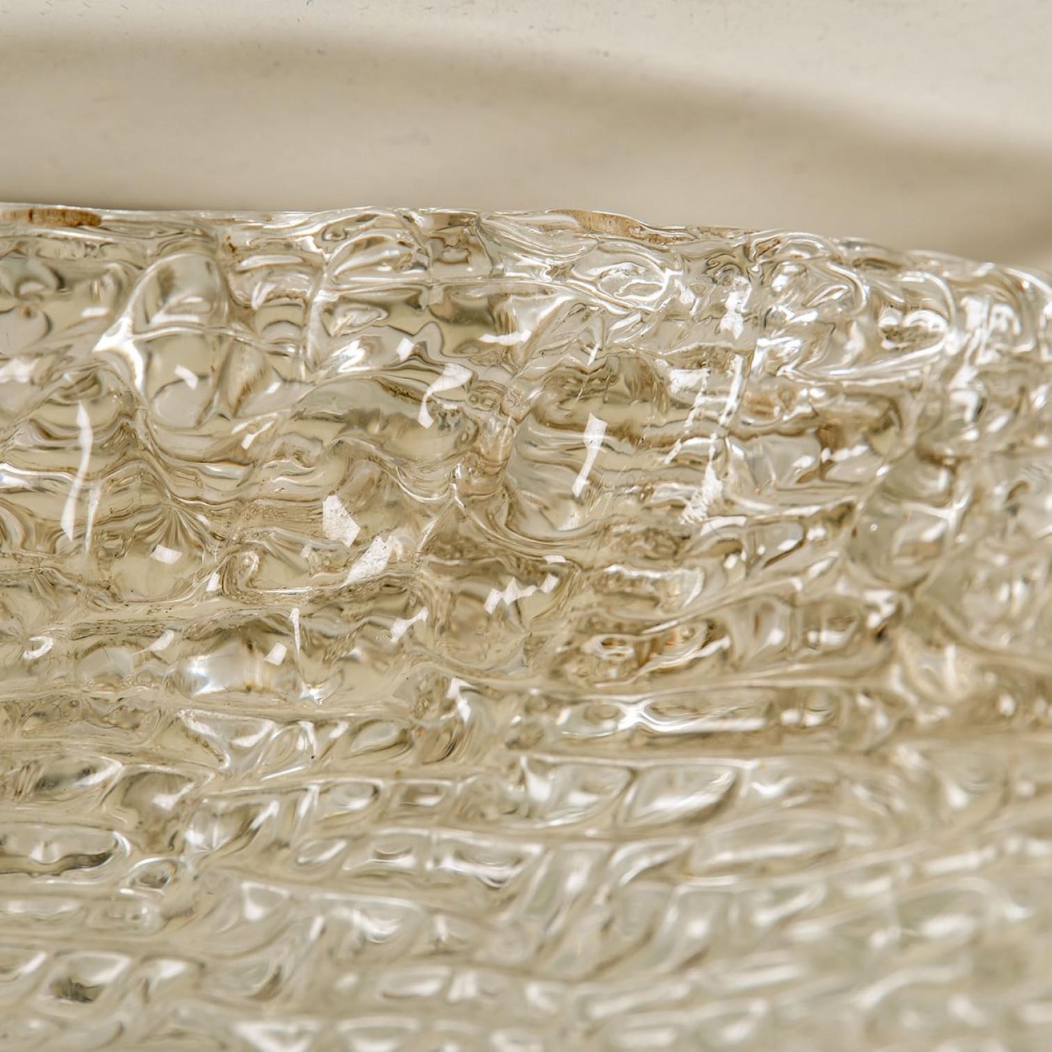 High quality modern thick textured ice glass flush mount. Made by the company Hillebrand, Germany in circa 1965. The flush mount features an impressive huge round handmade glass dish. The back plate is made of white metal. Can also work as an
