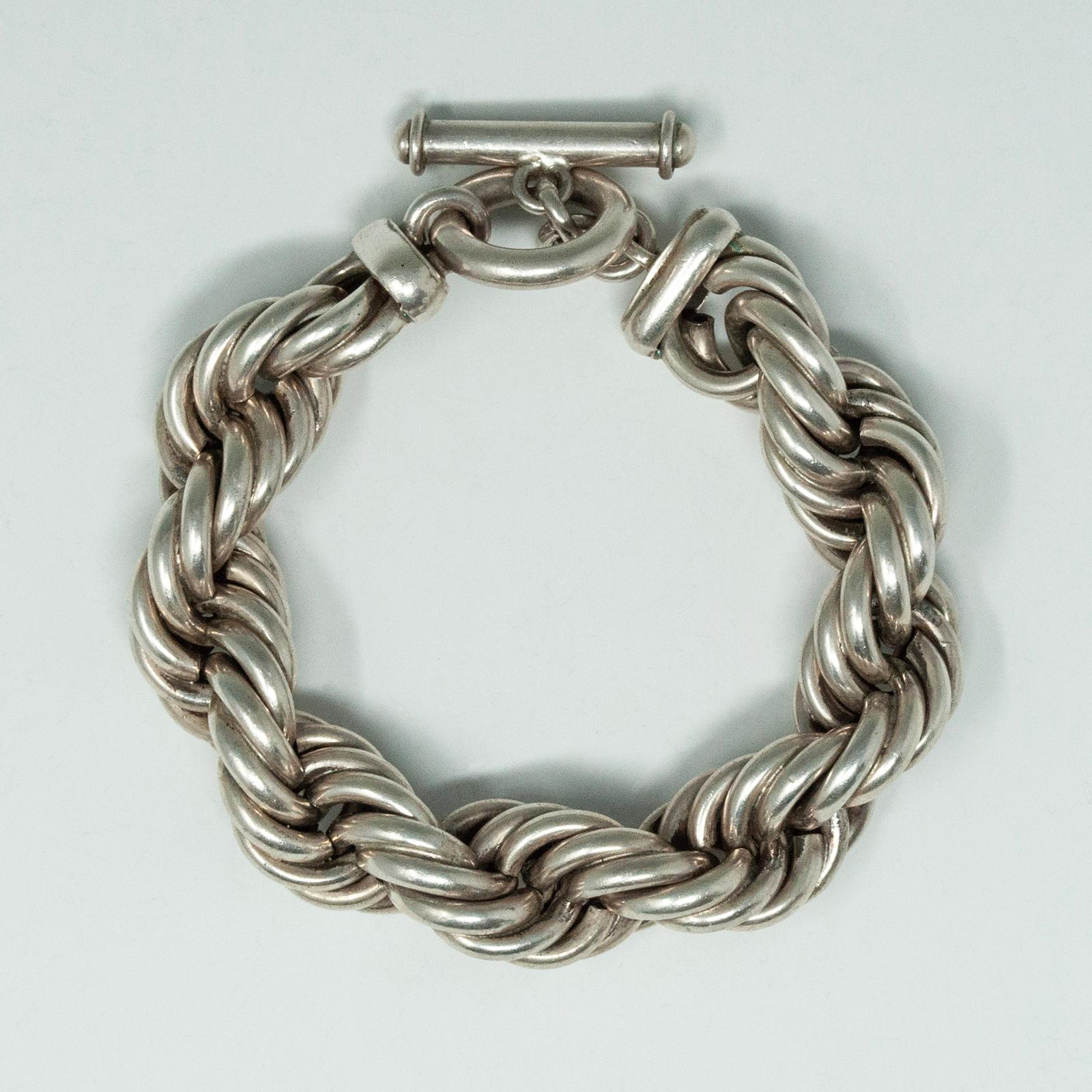 Thick Silver Twisted Rope Bracelet, Taxco .950

A dramatic thick hand-made twisted rope .950 silver bracelet from Taxco, Mexico, with a toggle clasp. It measures 9.5 inches long and .75 inches wide, with a weight of 129 grams. Interior diameter is