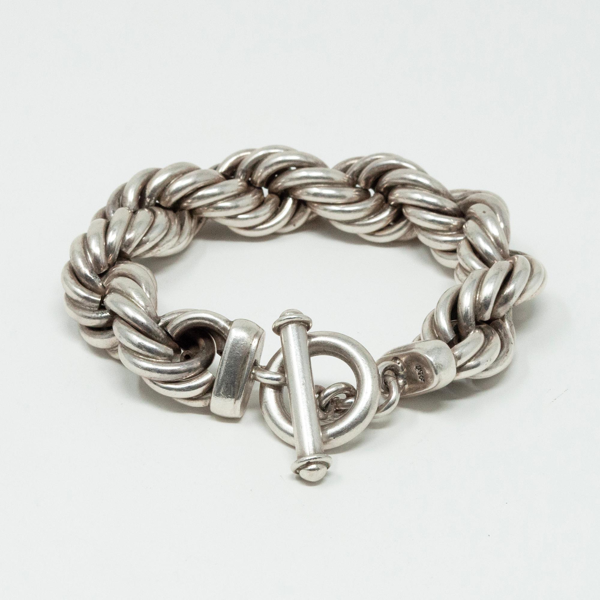 Thick silver twisted rope bracelet from Taxco, Mexico

A thick silver twisted rope bracelet from Taxco, Mexico with a toggle clasp, measures 9 inches long and .75 inches wide, and weighs 126 grams. .925 stamped on clasp.
Free shipping within the