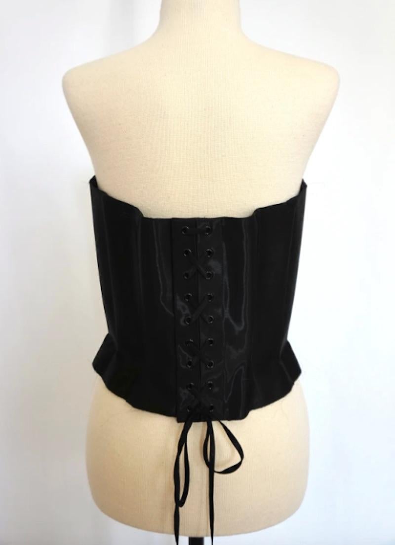 Thierry Mugler 1980s Black Corset Top. This stunning corset creates a powerfully feminine shape with its waist cinching construction and shape. Perfectly representing Mugler's eye for chic boldness, this corset is a coveted piece of fashion history