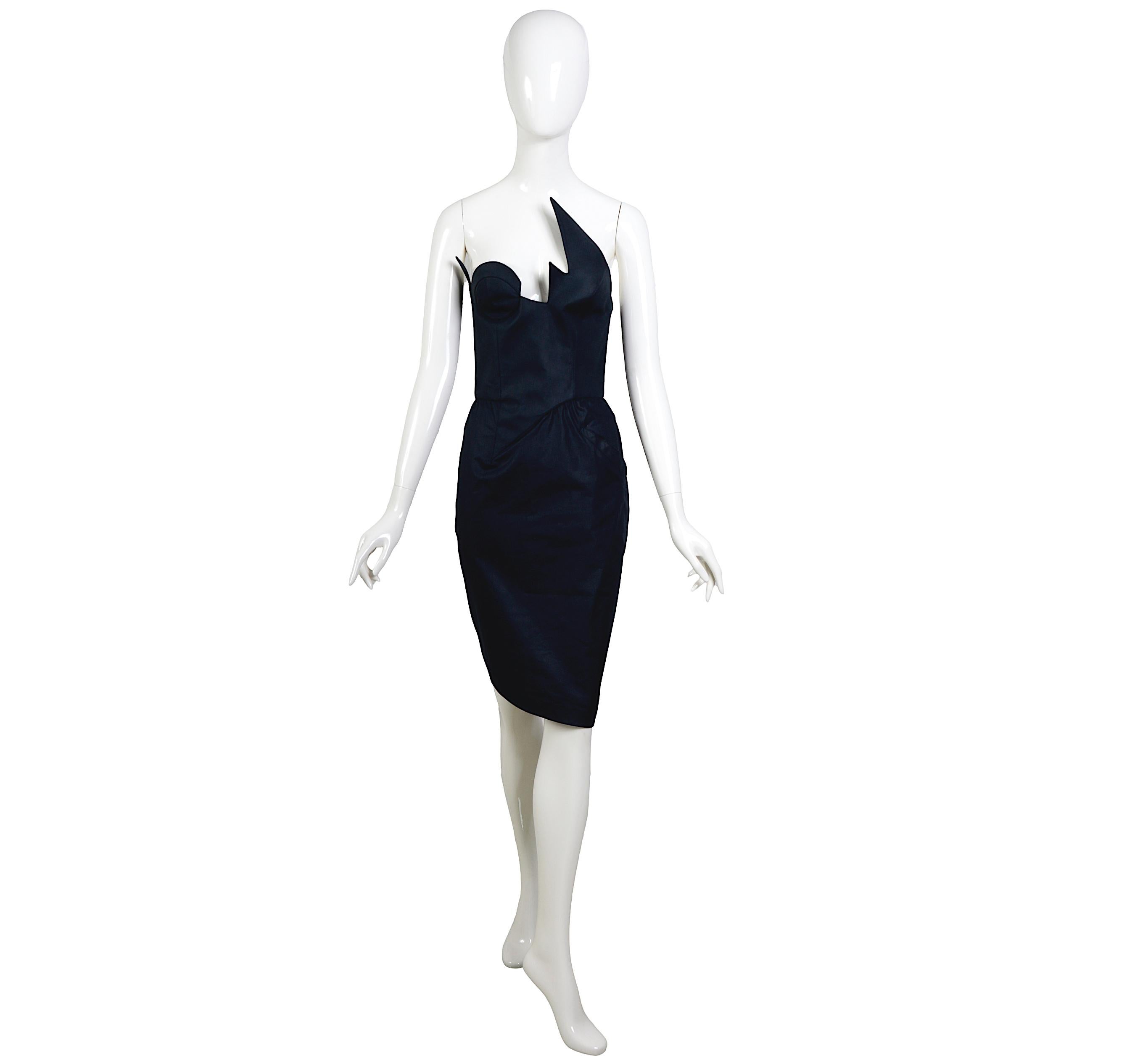 Exceptional and Rare Thierry Mugler 1980s Vintage Black Cotton Boned Bustier Corset Dress

Rare and hard to find, this stunning Thierry Mugler dress is likely from the Spring 1985 collection. While the exact date is uncertain, it is unmistakably