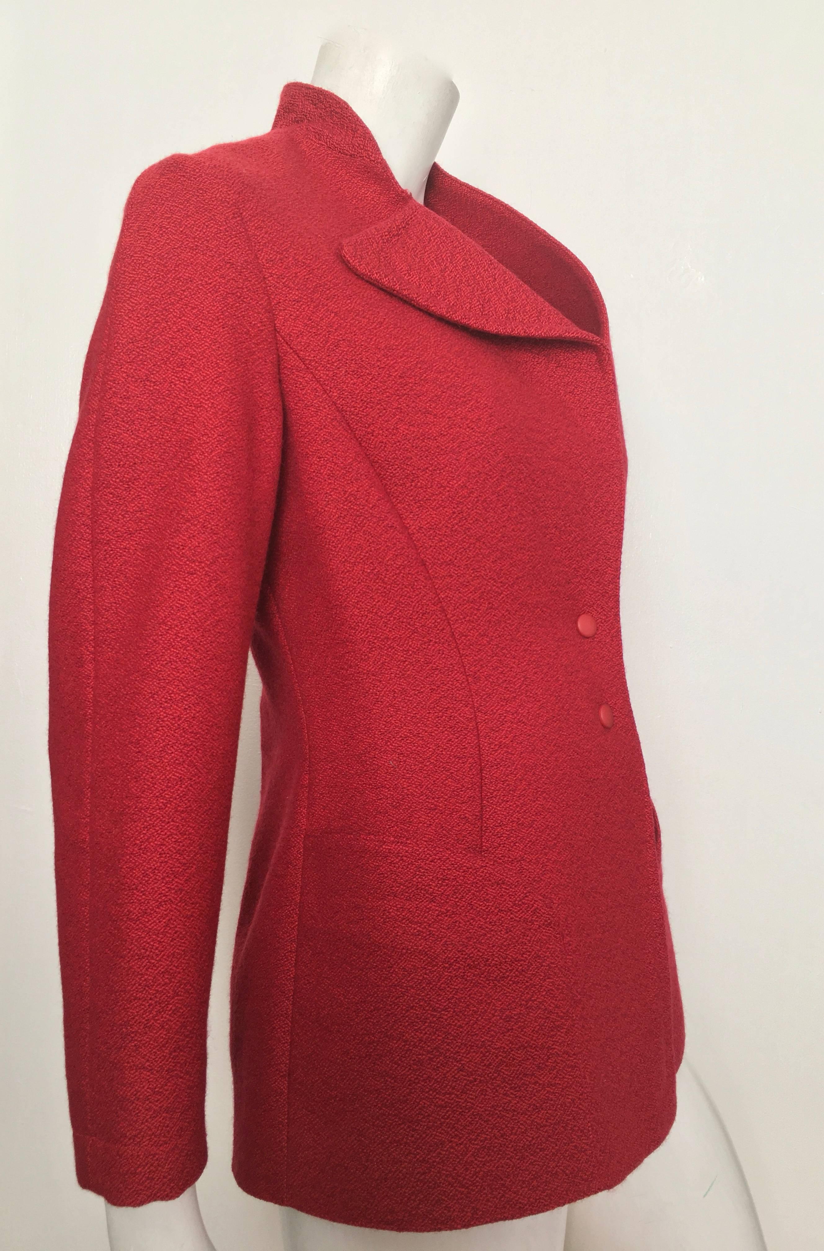 Thierry Mugler 1990s red wool sculptural snap button jacket with pockets will fit a size 8. Curved front pockets with singular lapel jacket is a great example of this infamous French fashion designer's vision. This sexy & stylish jacket is just as