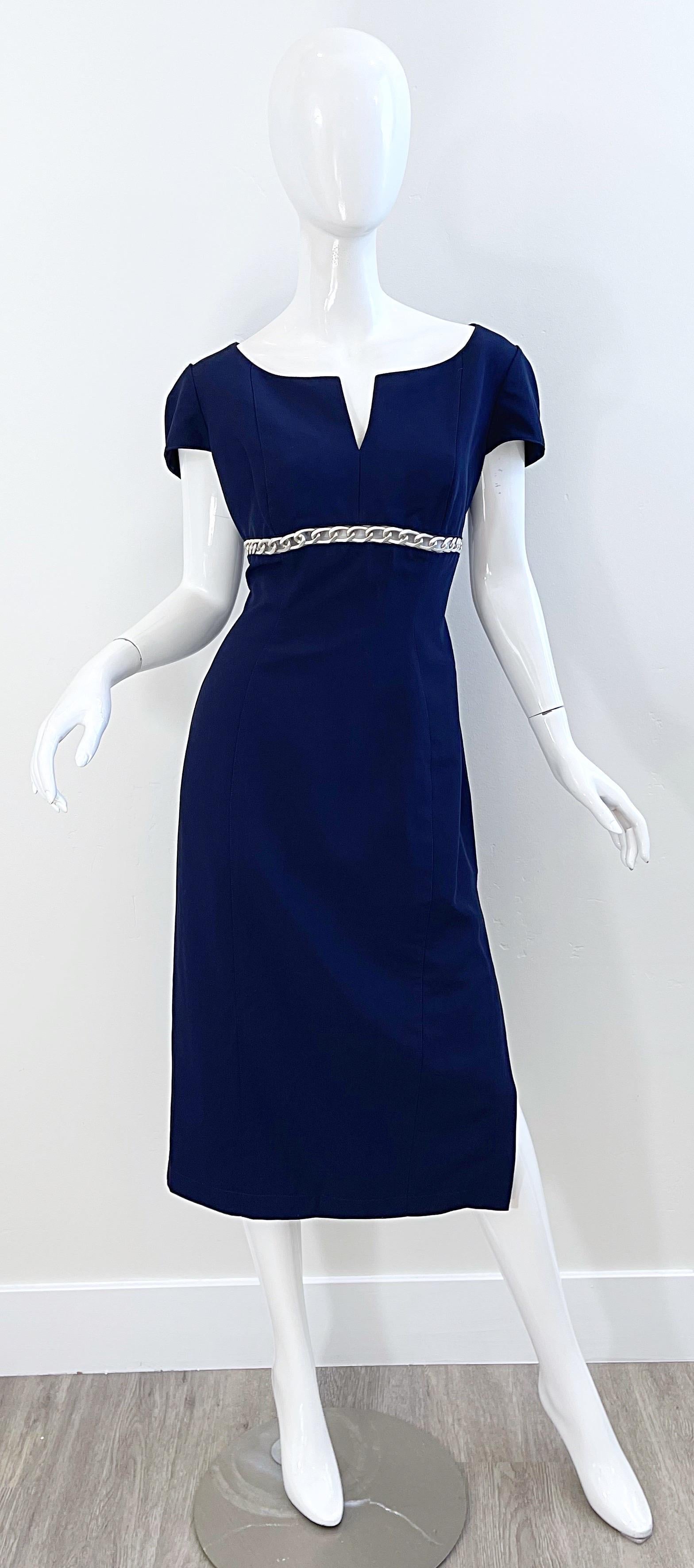 Chic and sexy early 90s THIERRY MUGLER navy blue pin-up style dress ! Features silver chain cut-out detail under the bust. Hidden zipper up the back with hook-and-eye closure. Slit on the left hem reveals just the right amount of leg. Fully