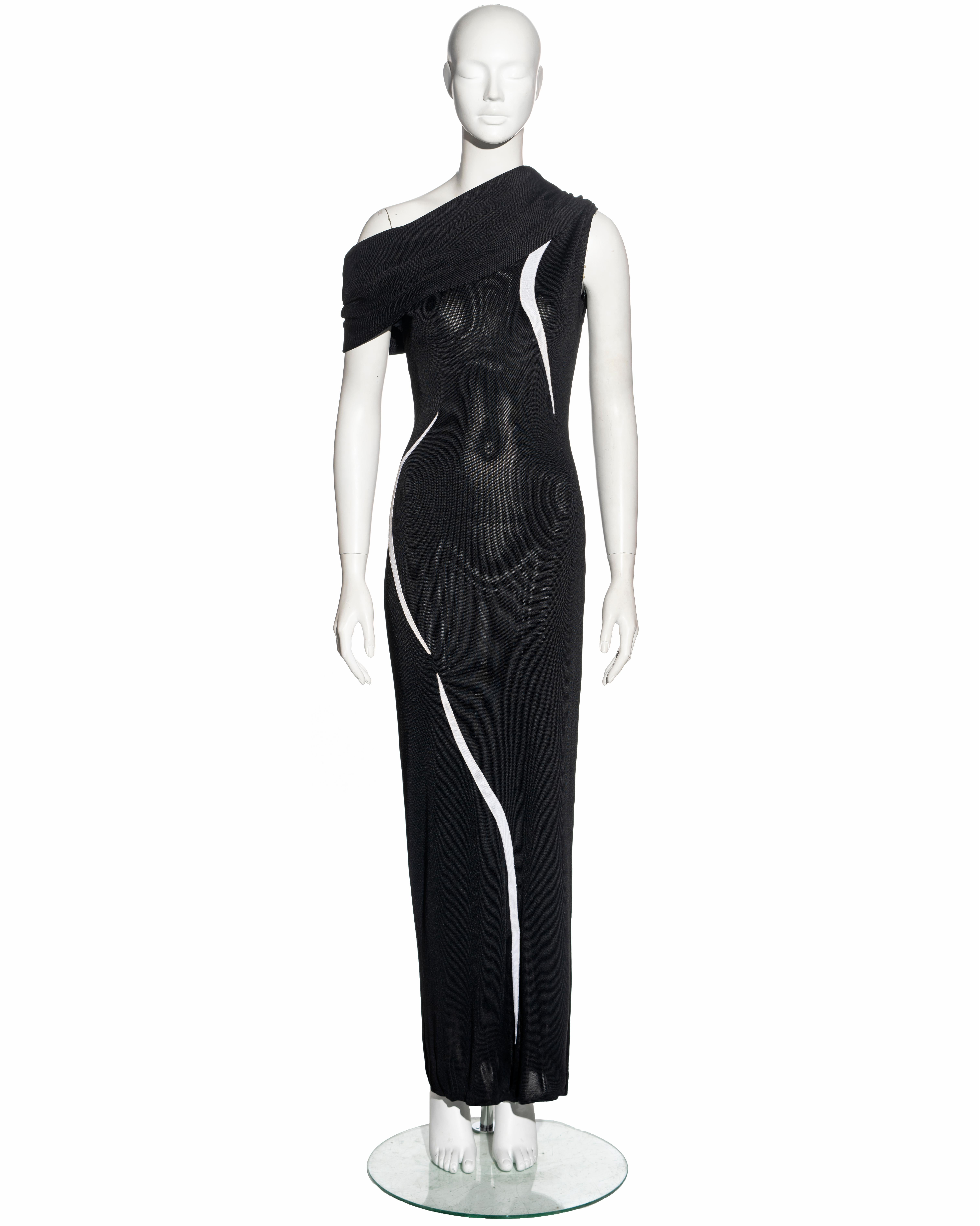 ▪ Thierry Mugler evening dress
▪ Sold by One of a Kind Archive
▪ Constructed from black knitted rayon 
▪ Inserts of white curved lines 
▪ Asymmetric off-shoulder neckline with draped cowl 
▪ Floor-length skirt with leg slit 
▪ Size: FR 38 - UK 10 -