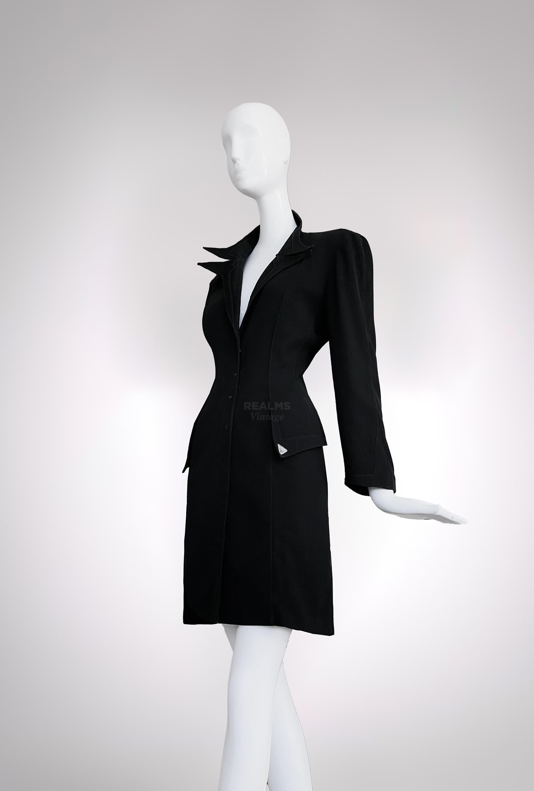 Beautiful rare Thierry Mugler piece. Black light jacket / coat with dramatic pointy collar. Long jacket that closes with press buttons on the front. Soft and light fabric, assuming cotton/wool blend. Two lapels at the waist to exaggerate the