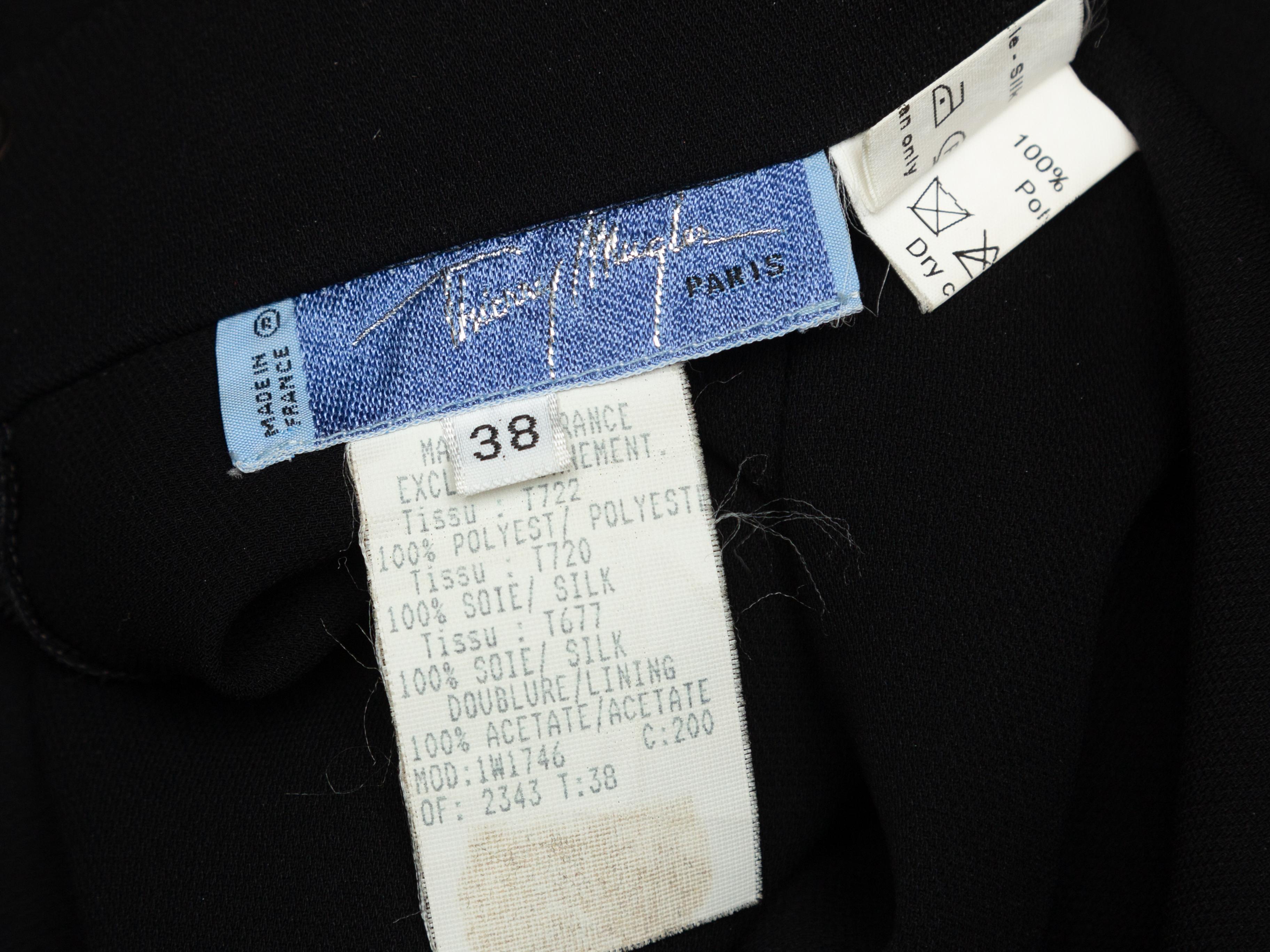 Product details: Vintage black open side pants by Thierry Mugler. Zip and button closures at front. Designer size 38. 24