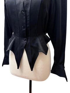 Chaqueta de Thierry Mugler de satén negro, estilo vampírico gótico y corte escultural con puntas