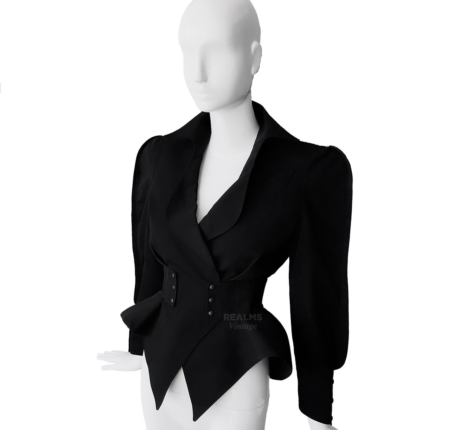 
Stunning rare Thierry Mugler Creation. 
Dramatic sculptural black jacket, a beautiful example of his superb tailoring and unique design. Dramatic pointy collar, fitted waist and exaggerated peplum hips. Closes with press buttons on the waist. Also
