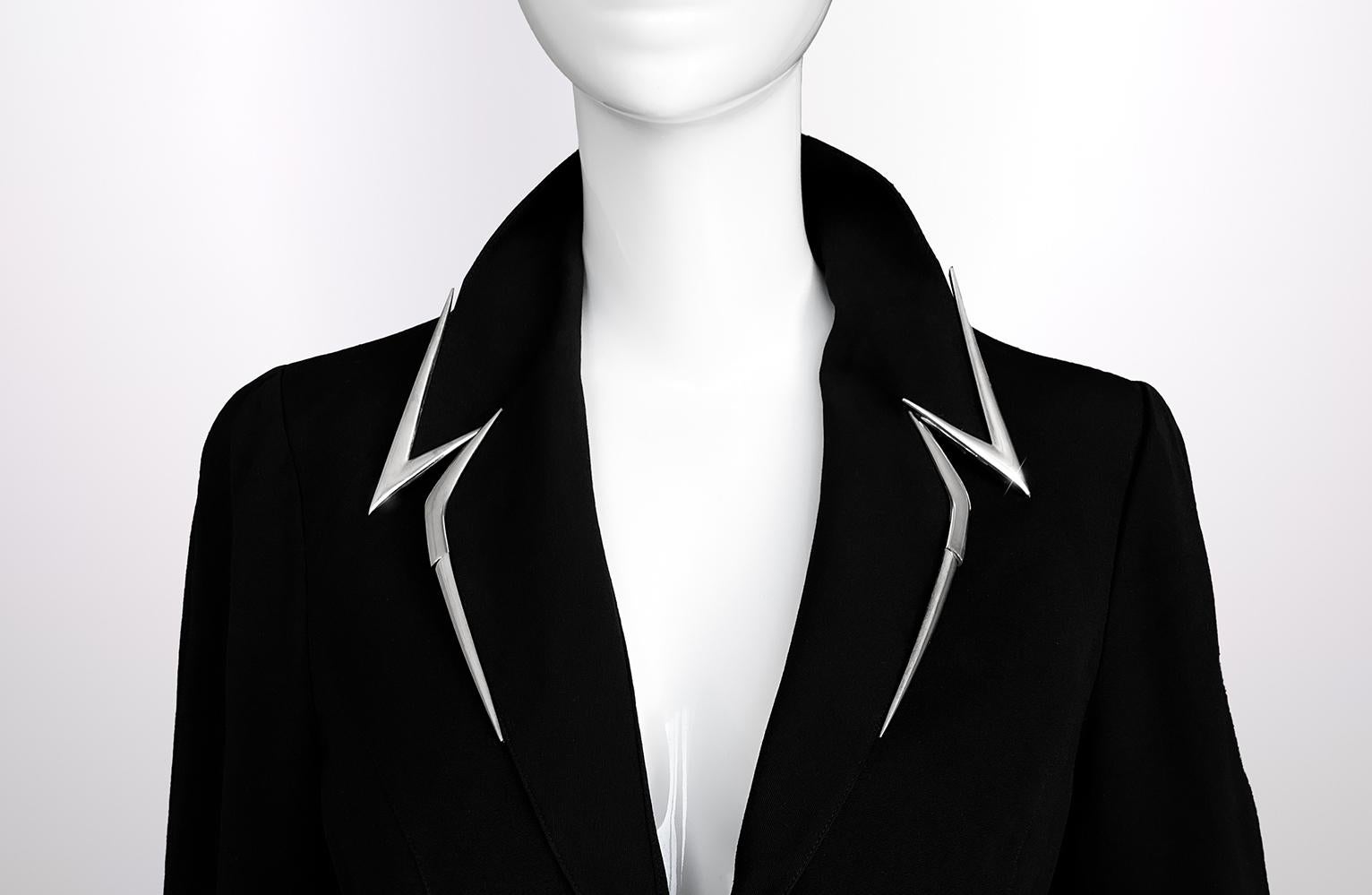 Precioso traje Thierry Mugler (chaqueta y falda) de la Colección Les Salades Primavera/Verano 1999, una clase magistral de electricidad y energía sartoriales. Confeccionada con precisión en lana negra, la silueta es puro Mugler: una oda a la