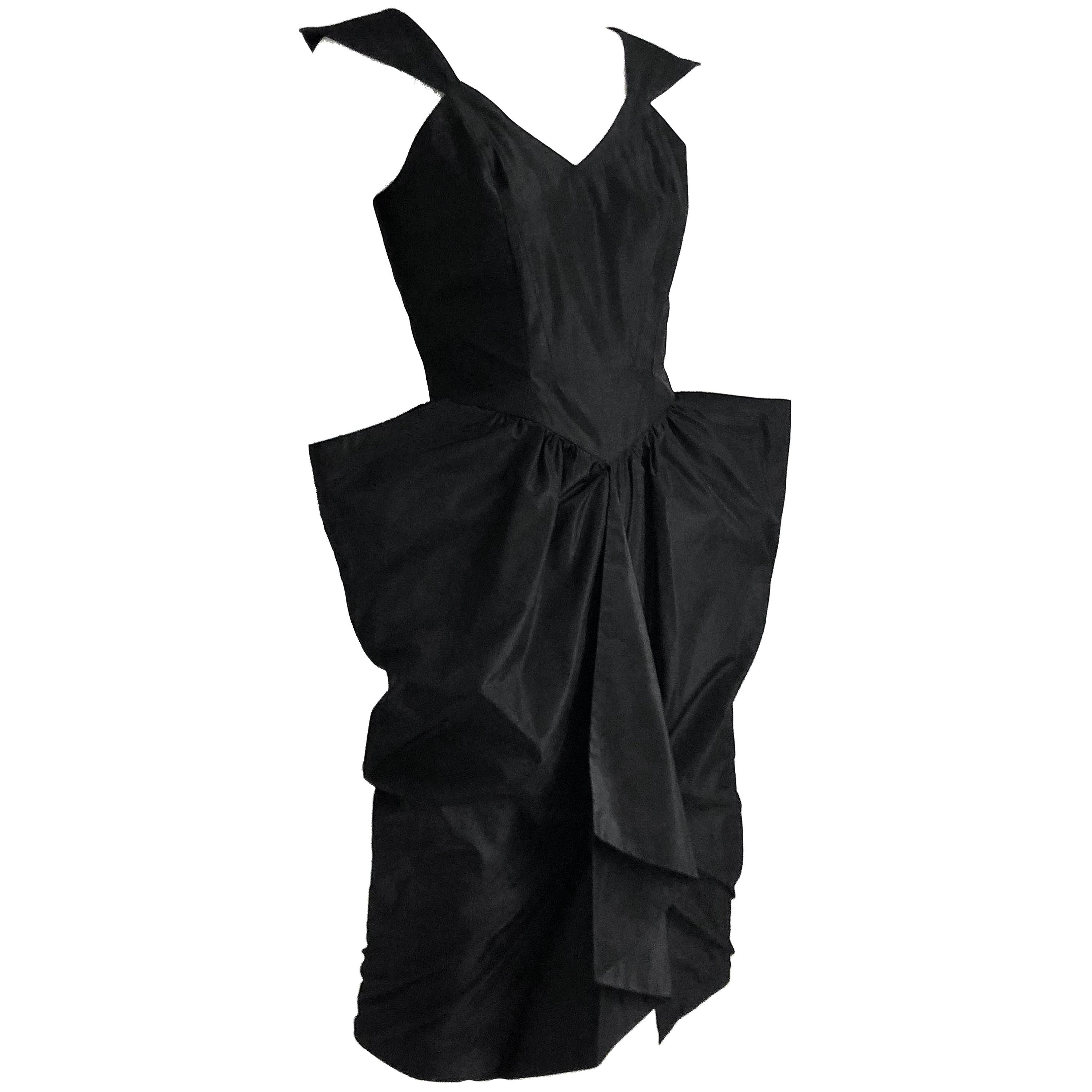 Vintage Thierry Mugler sculptural little black dress from the 90s.  Timeless sihouette. Fully-lined, made from taffeta, fastens with rear zipper/hook & loop.  Fitted bodice with pointed cap sleeves and front skirt vent with incredible sculptural hip