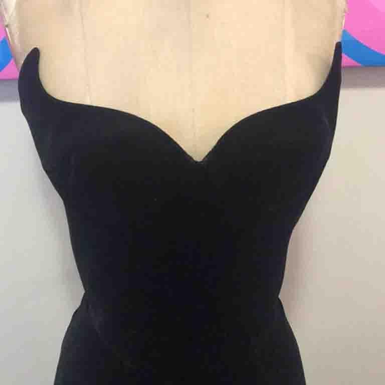 This museum worthy dress by Thierry Mugler has the iconic bustier style top. Signs of wear inside with boning coming out in one area and a few signs of wear on the inside lining. From a temporary alteration this has stitch marks on inside lining in