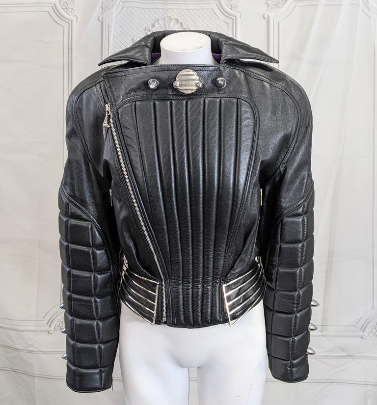 Thierry Mugler motorcycle jacket, Fall/Winter 1989. The motorcycle jacket is a constant leit motif of Mugler. This jacket  of black lamb skin leather, employs the motorcycles seat detailing and upholstered padding for the jackets' body and arms.