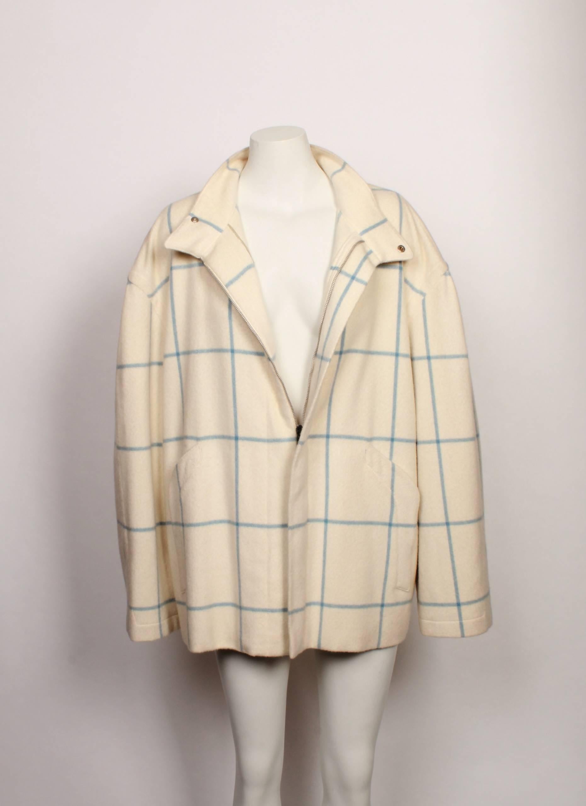 Thierry Mugler egg-shell winter coat with blue detailing composed of wool & angora features a collar with center front snap front closures. Made in Italy. 
