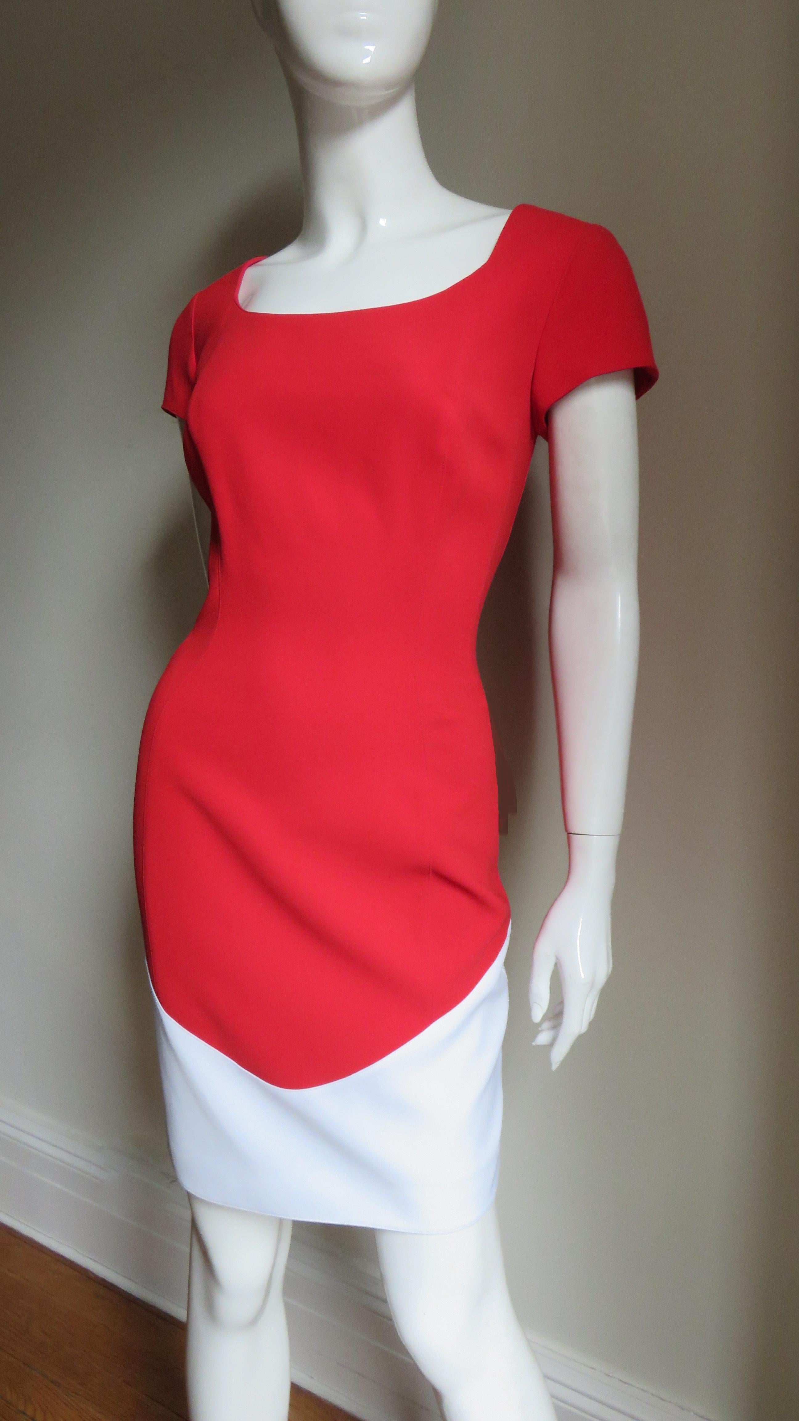 A beautiful red and white color block dress from Thierry Mugler.  It has short sleeves, a scoop neckline front and back and princess seaming with cleaver seaming and insets emphasizing the waist.  The lower portion of the straight skirt has a wide