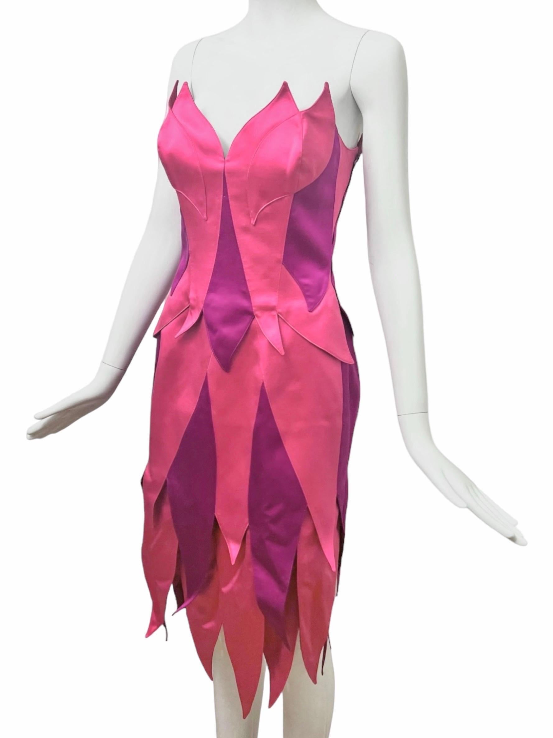 Create a statement in this enchanting Thierry Mugler Couture bustier and skirt ensemble. This rare silk two piece ensemble features a striking colorblock pattern in rich and vibrant shades of pink and violet resemblant to a fairy. 

Constructed with