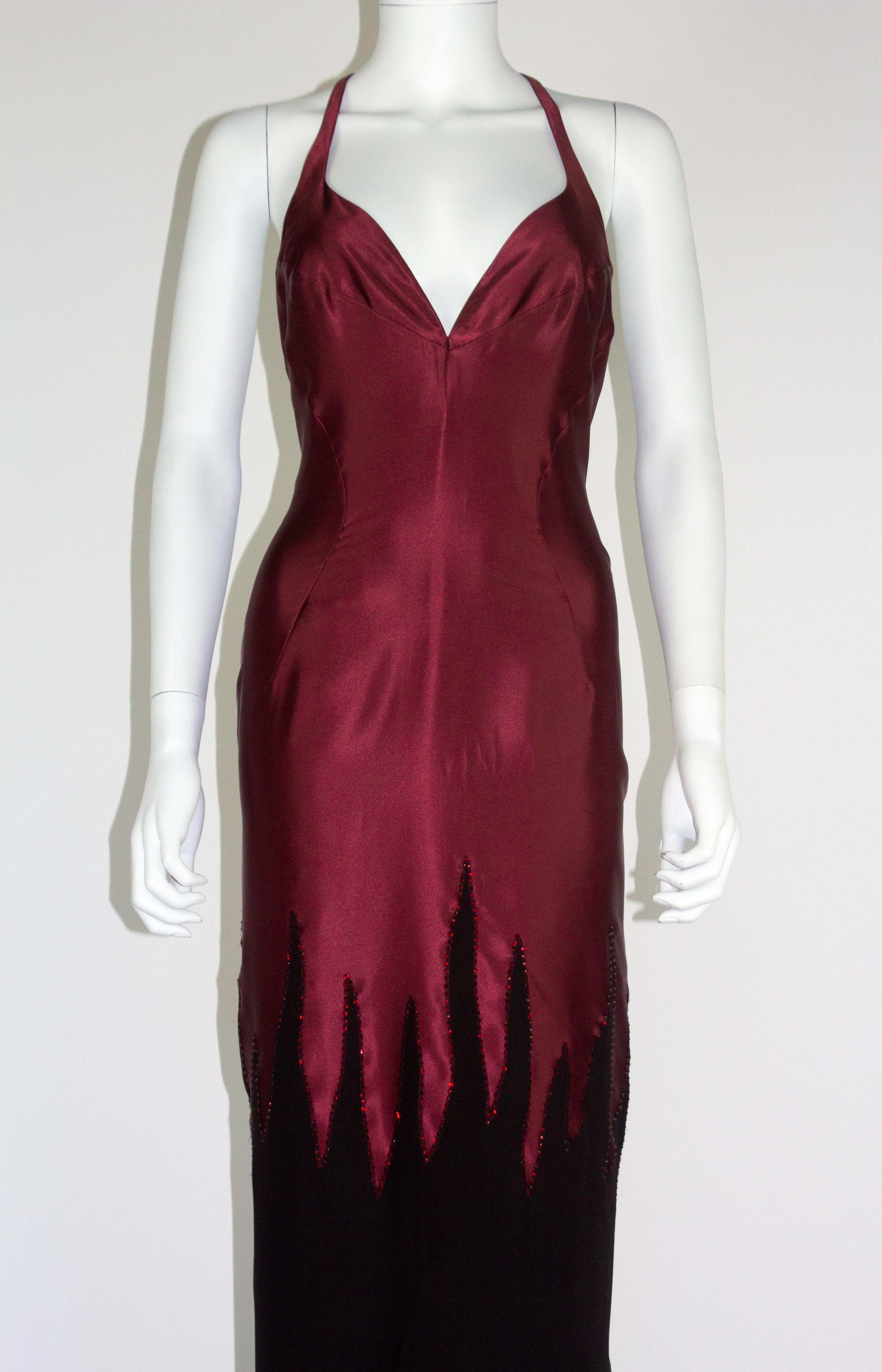 Vintage Thierry Mugler couture dress, in wine red/deep purple liquid silk, with a black chiffon hem detailed with a glass beaded flame tip design. Circa 2000. This is the exact dress worn by the singer Raye, who wore it to her performance at the
