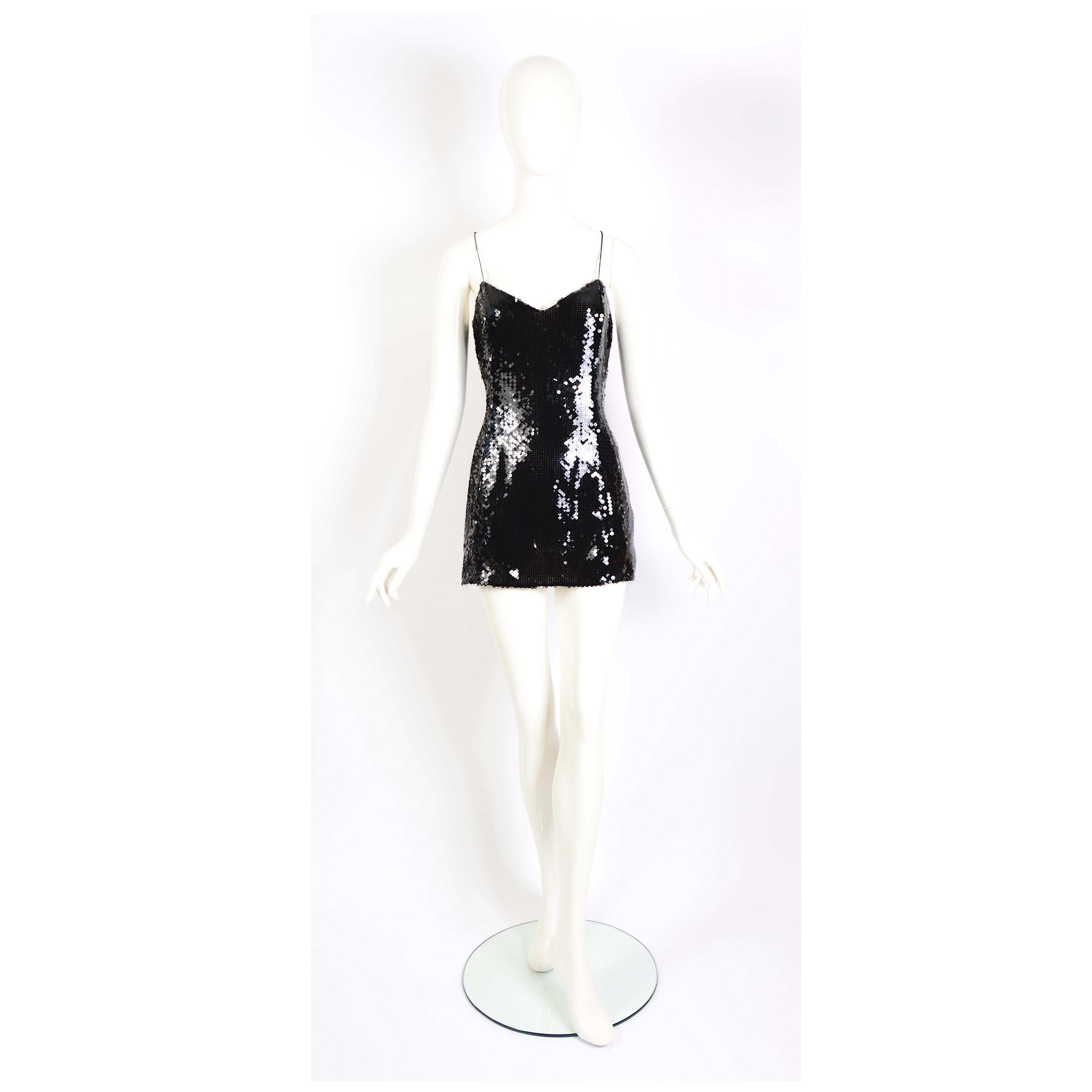 Adorable light as a feather Thierry Mugler couture Nr 1K710 vintage 1990s black sequins mini party dress or top.
Fully lined with a silk nude transparent fabric.
In good vintage condition, the side zipper of the dress closes with difficulty because