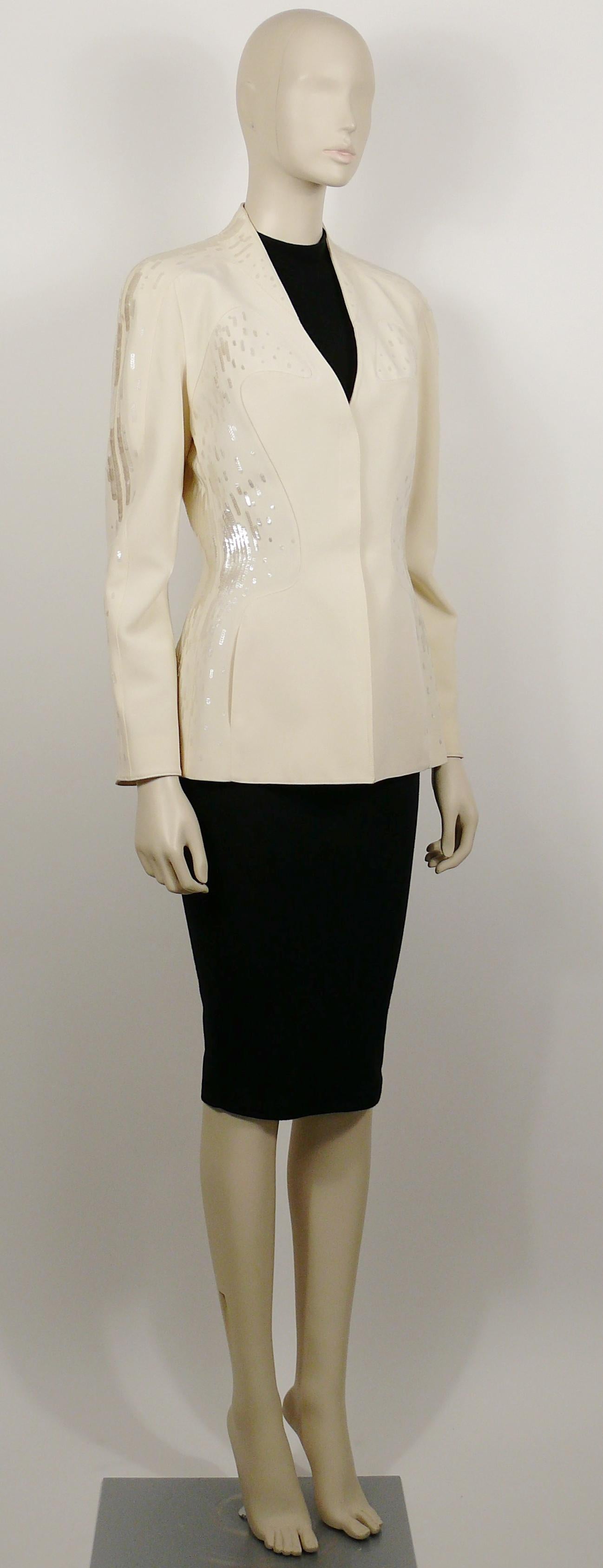 THIERRY MUGLER COUTURE vintage off white sequined jacket.

Hidden snap button down front closure.
Two side pockets.
Fully lined.
Shoulder pads.


Label reads THIERRY MUGLER COUTURE.
Made in France.

Size tag reads : 38.
Please check
