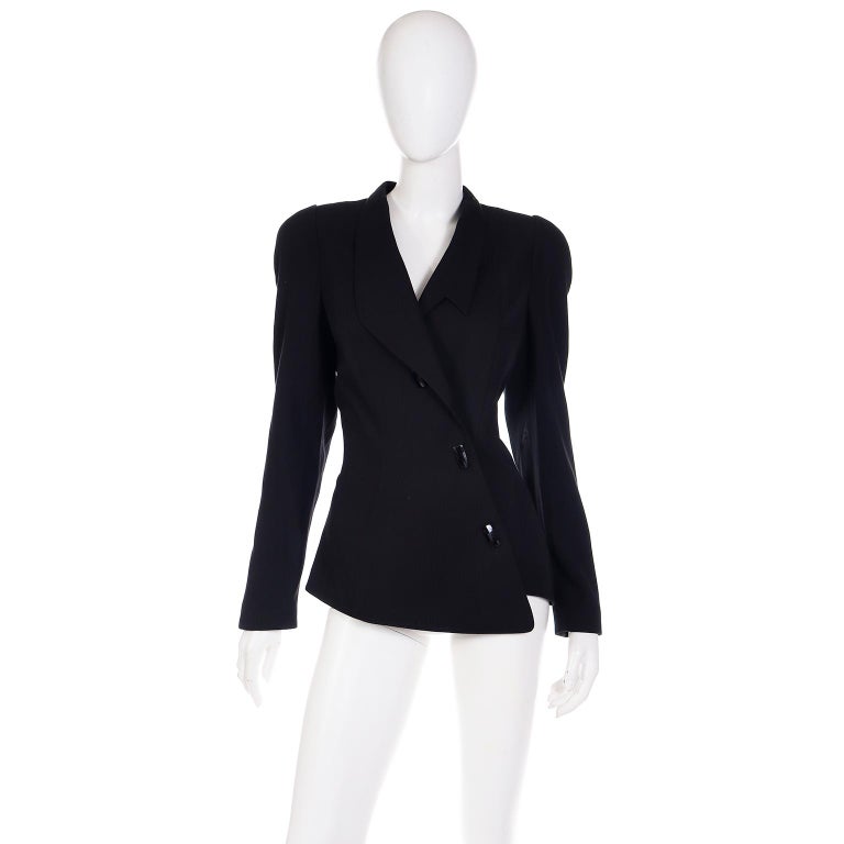 This vintage Thierry Mugler Act IV jacket was never worn and still has its original tags attached.  This gorgeous fitted blazer has an asymmetrical design and is made of 65% wool and 35% viscose.There are two snap closures along center front with
