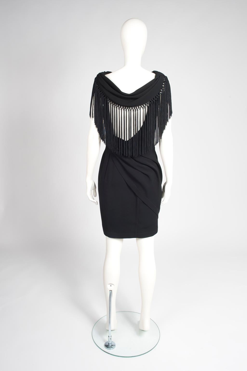Brilliantly constructed, this 90s Thierry Mugler is a wonderful example of his work. Cut from soft black viscose, the dress is artfully draped and gathered to produce a wrapping effect around the body, beautifully emphasizing feminine curves.