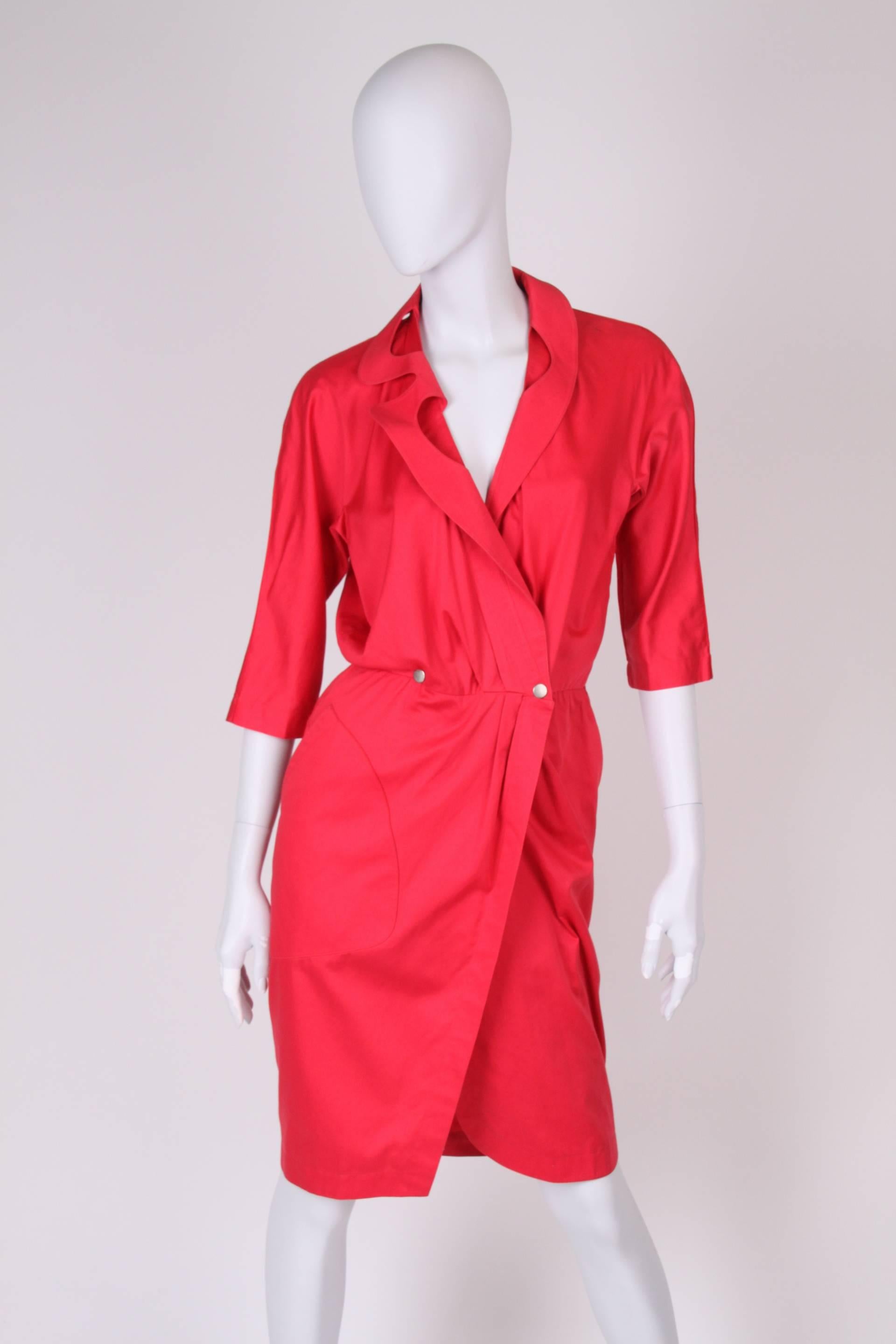 Raspberry red dress by Thierry Mugler from the eighties, this one shines right at you!

This cotton dress has a little bit more than knee-length and typical Mugler lapels with some cleavage. Waist closure with two matte silver push buttons. 3/4