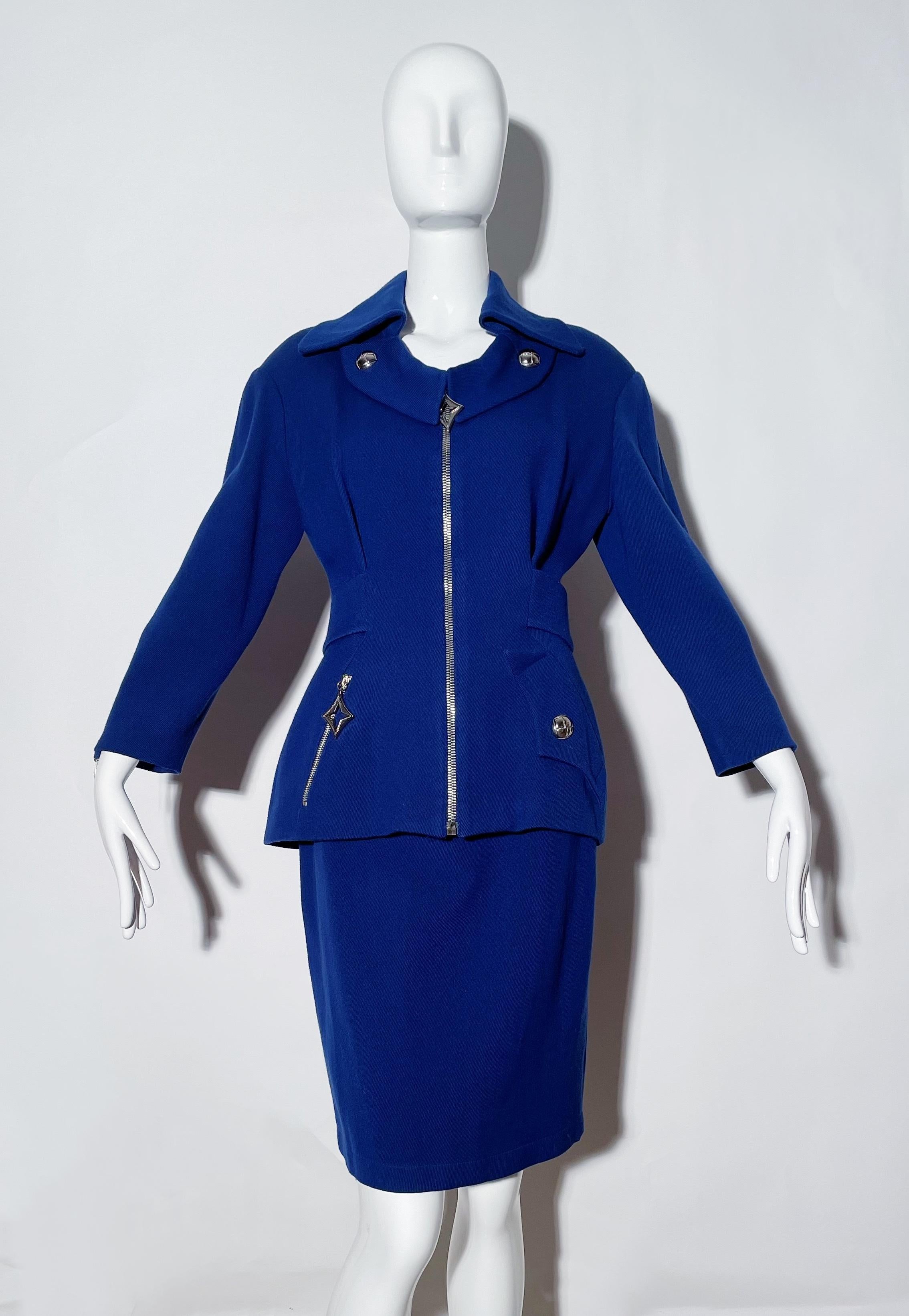Electric blue skirt suit. Large collar. Front zipper. Front pockets. Belted blazer. Shoulder pads. Rear snap closure on skirt. Rear slit on skirt. Lined. Wool. Made Italy. 
*Condition: Excellent vintage condition. No visible Flaws. Tags have been