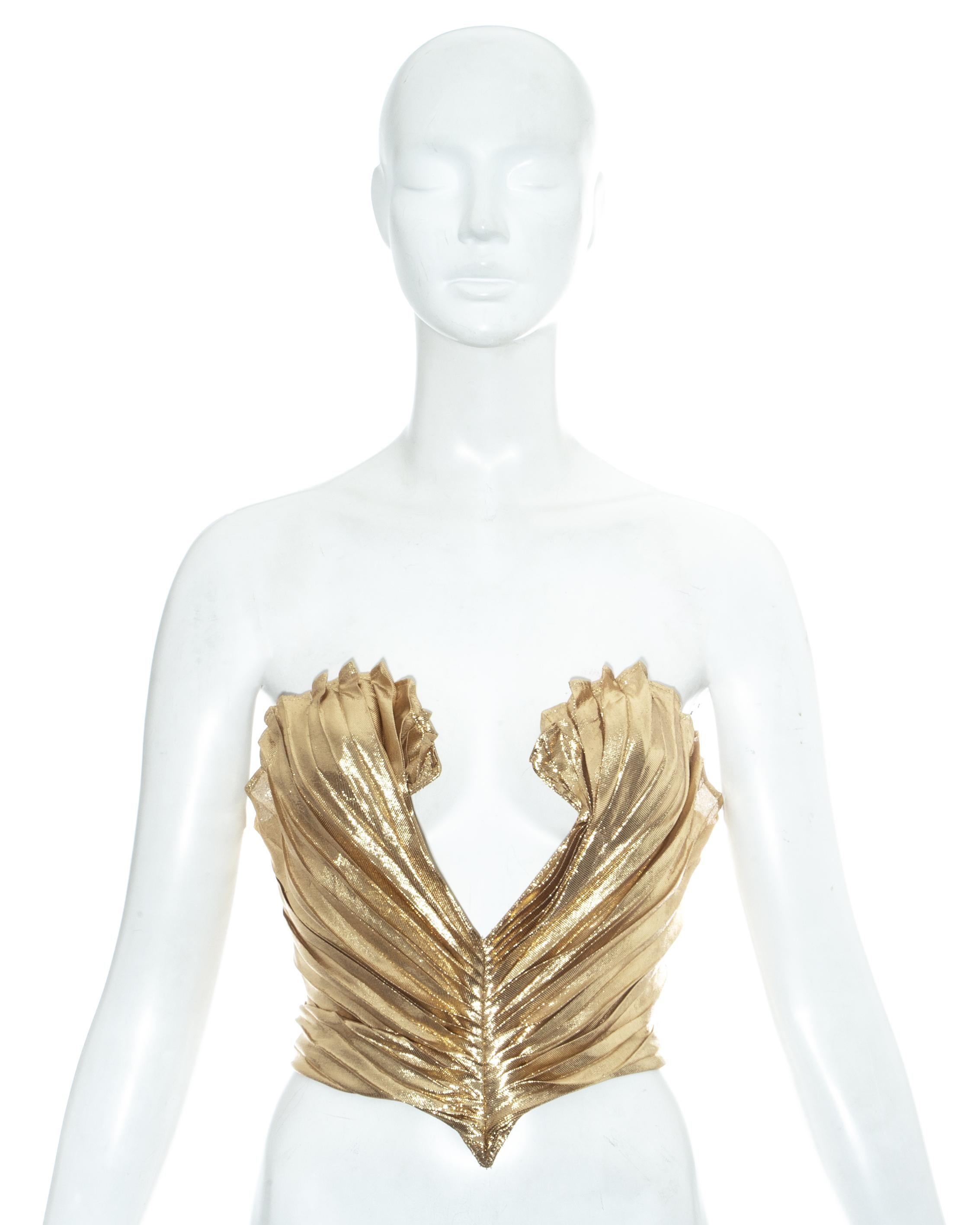 Thierry Mugler gold lamé corset bustier with scalloped edge, pleating throughout and low cleavage. Designed to cinch the waist and push the breasts up

Spring-Summer 1985