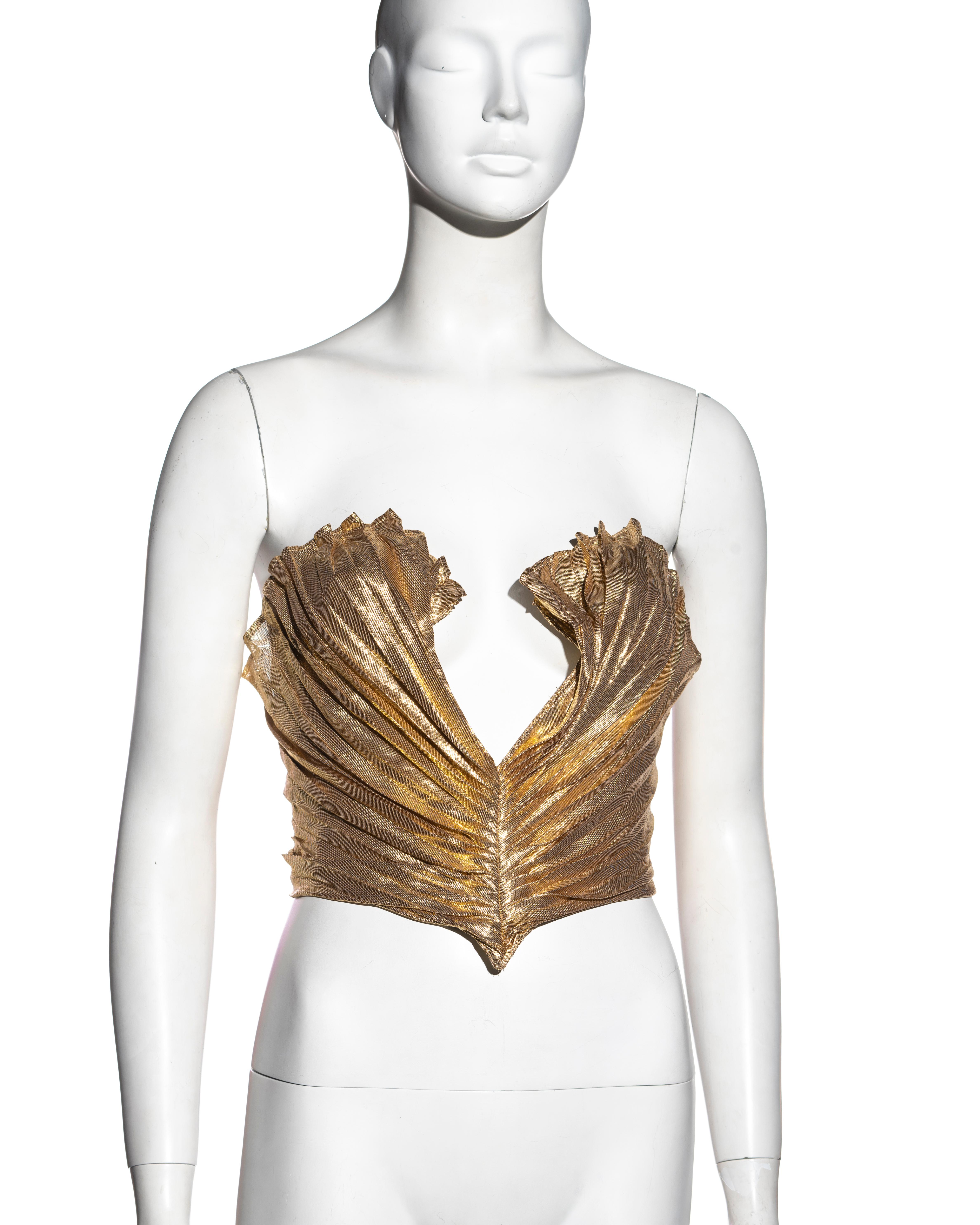 ▪ Thierry Mugler gold pleated strapless corset
▪ Overlay refined with knife-pleats
▪ Built-in corset
▪ Plunging neckline
▪ Metal snap buttons and hook fastenings to the center-back opening
▪ 67% Silk, 33% Polyester
▪ FR 36 - UK 8 - US 4
▪