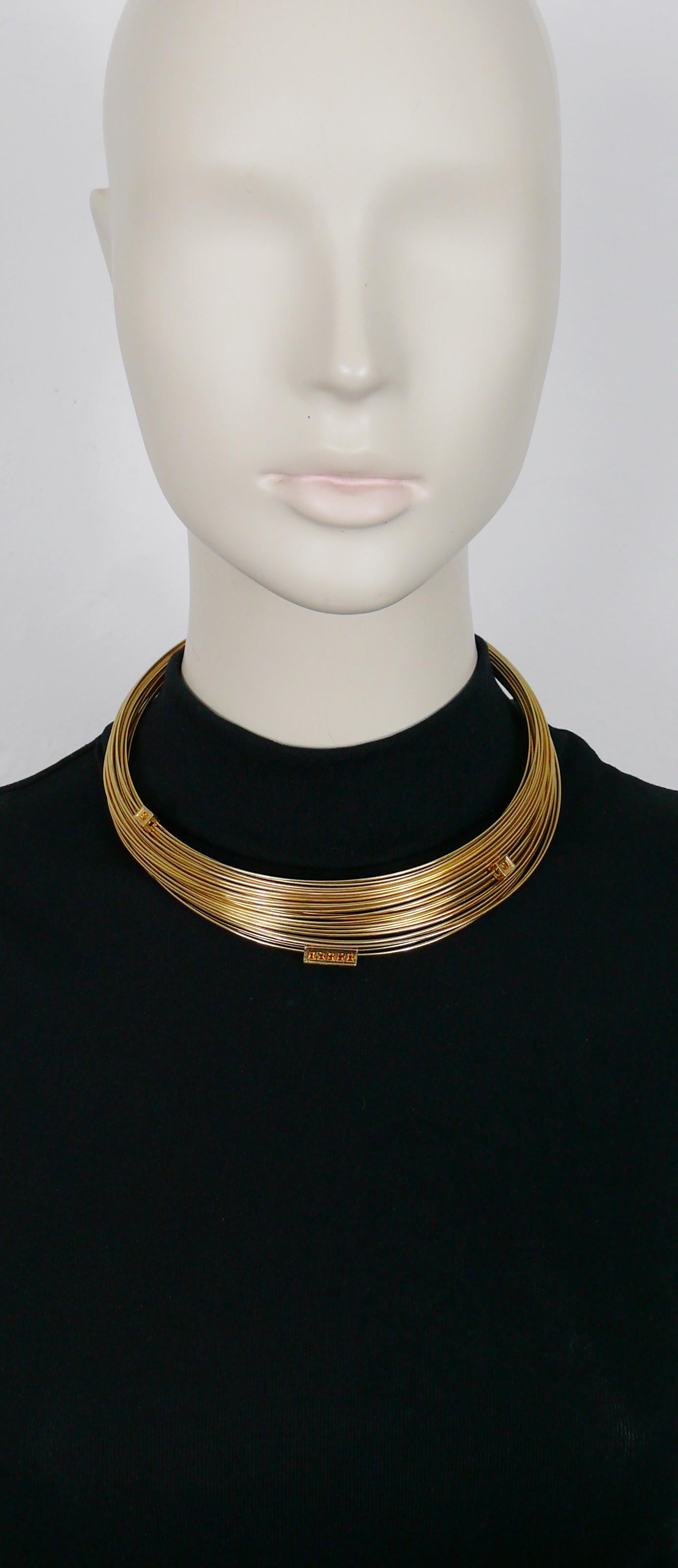 THIERRY MUGLER gold toned choker necklace made of bundled wires and featuring mobile elements embellished with orange crystals.

Embossed TM.

Indicative measurements : circumference approx. 41.15 cm (16.20 inches).

NOTES
- This is a preloved