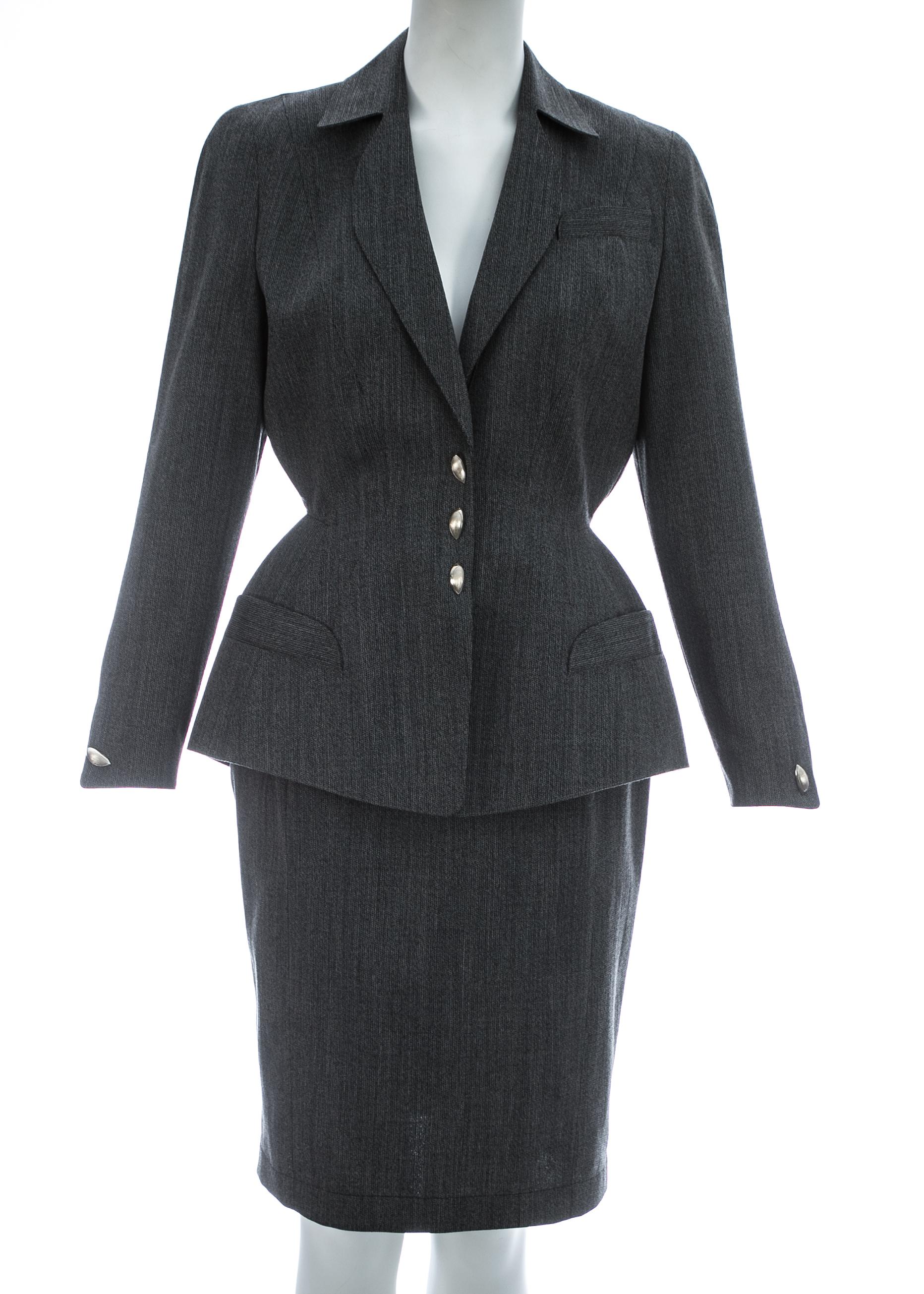 - Structured blazer jacket with cinched waist and exaggerated hips 
- Fitted pencil skirt
- Silver snap button closures

c. 1990s