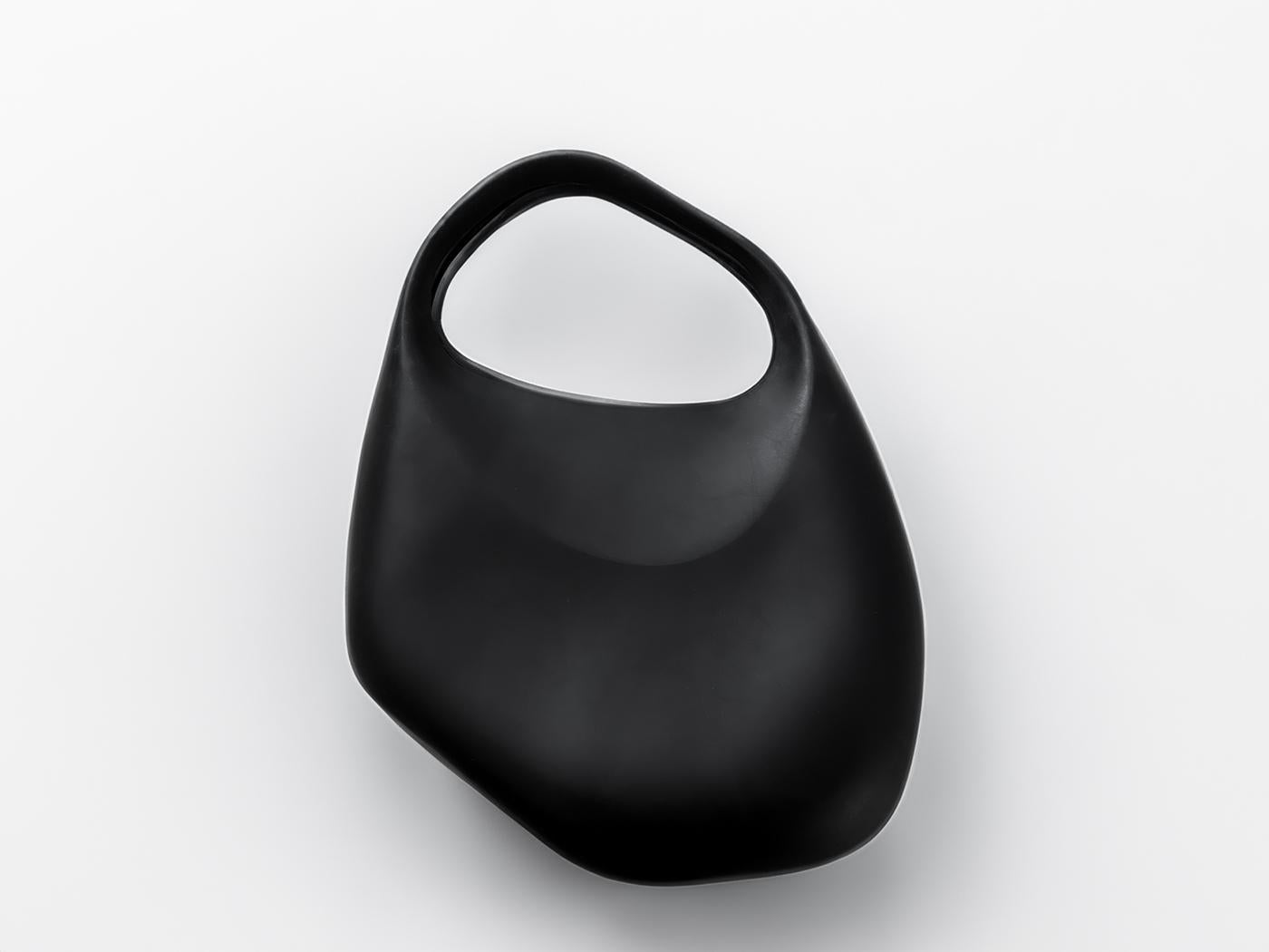 Rare Vintage Thierry Mugler futuristic rubber bag, Le Bubble, wearable Art. Its sinuous silhouette appears molded from a single piece of matte black rubber, yielding a smooth, cocoon-like form that feels simultaneously minimalist and otherworldly.