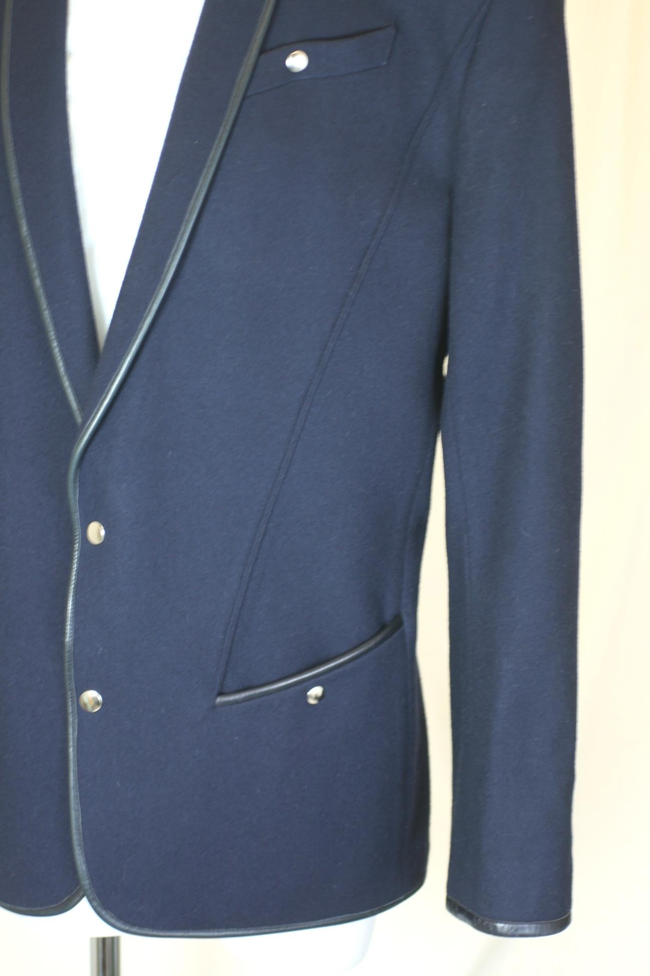 Thierry Mugler Iconic navy wool melton and leather trimmed blazer from the 1980's. Strong shouldered with tapering lines executed with Mugler's razor sharp cutting.  
Excellent condition. France 1980's. Snap closures. 
This model is also in the