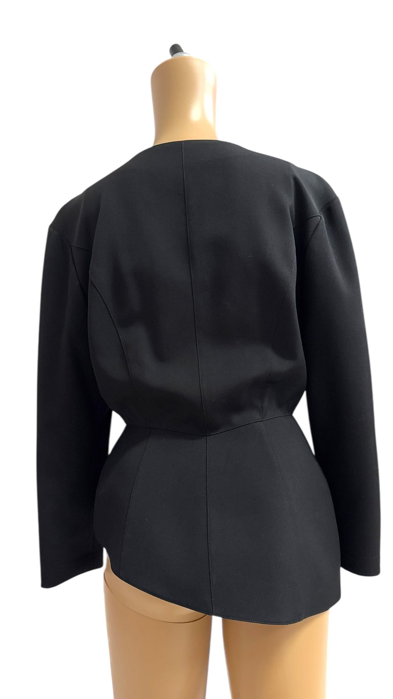 An extraordinary example of 1980s power dressing, this vintage black blazer by Thierry Mugler captures the designer’s unmistakable architectural style and bold silhouette. Expertly tailored in a structured fabric, the jacket features Mugler's